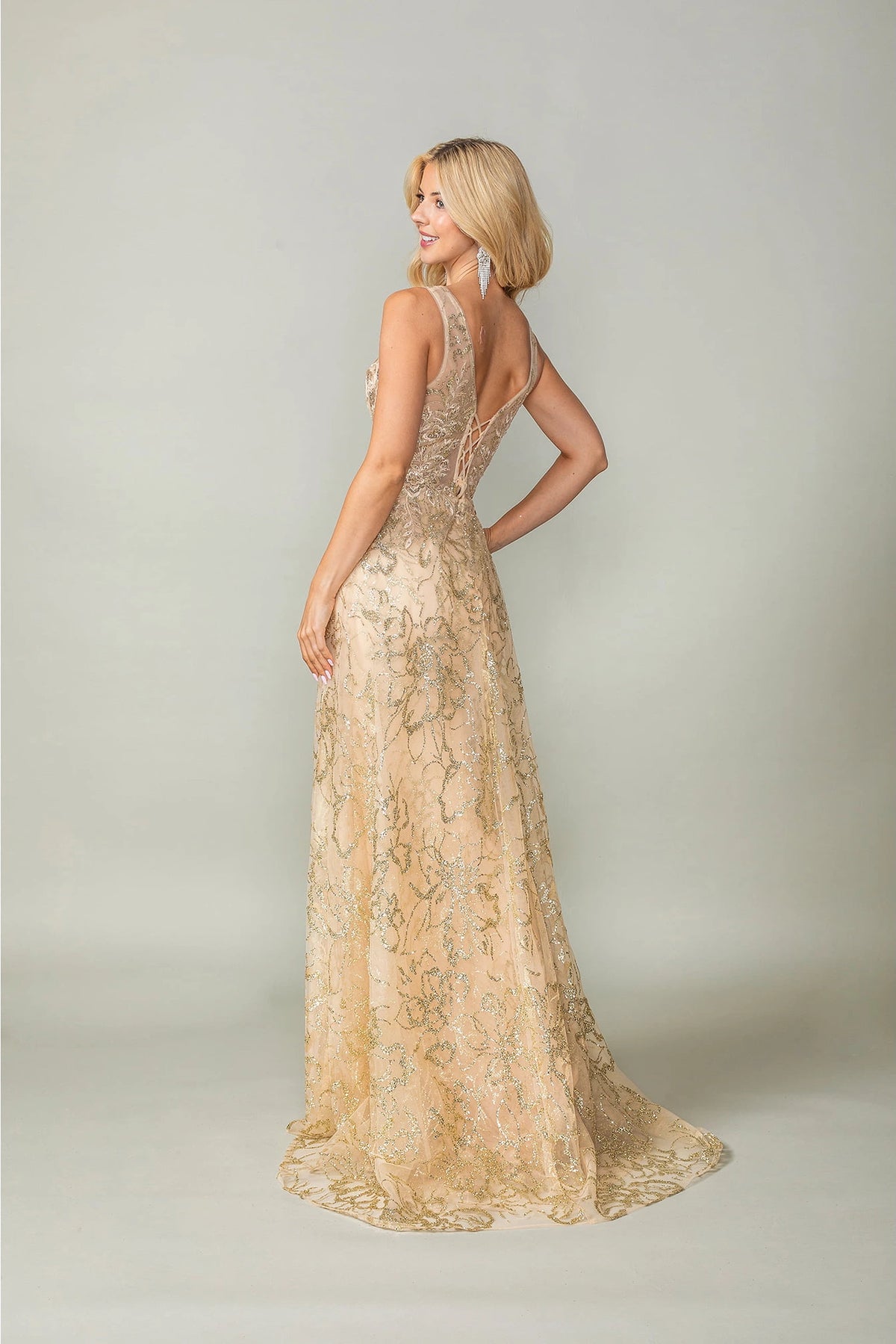 From the back, the Gold prom dress reveals its floor-length skirt.