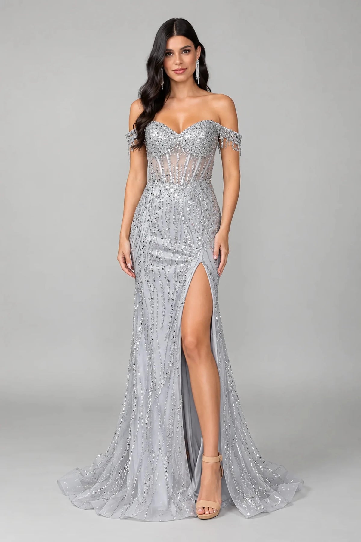 a floor-length off-the-shoulder evening gown covered in silver sequins and beads, high front slit, and slight train