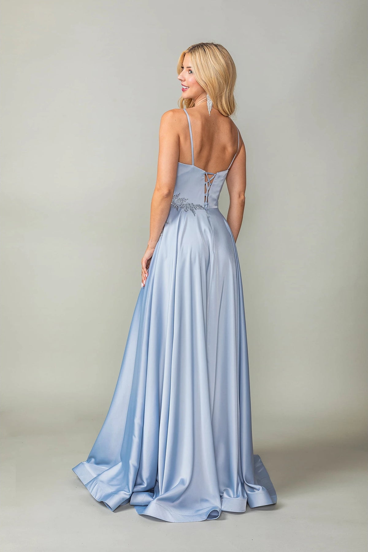 From the back, the Silver prom dress reveals its floor-length skirt.