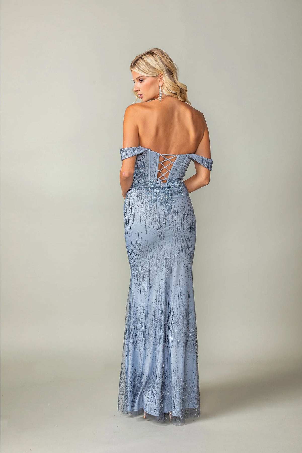 From the back, the Dusty Blue prom dress reveals its floor-length skirt.
