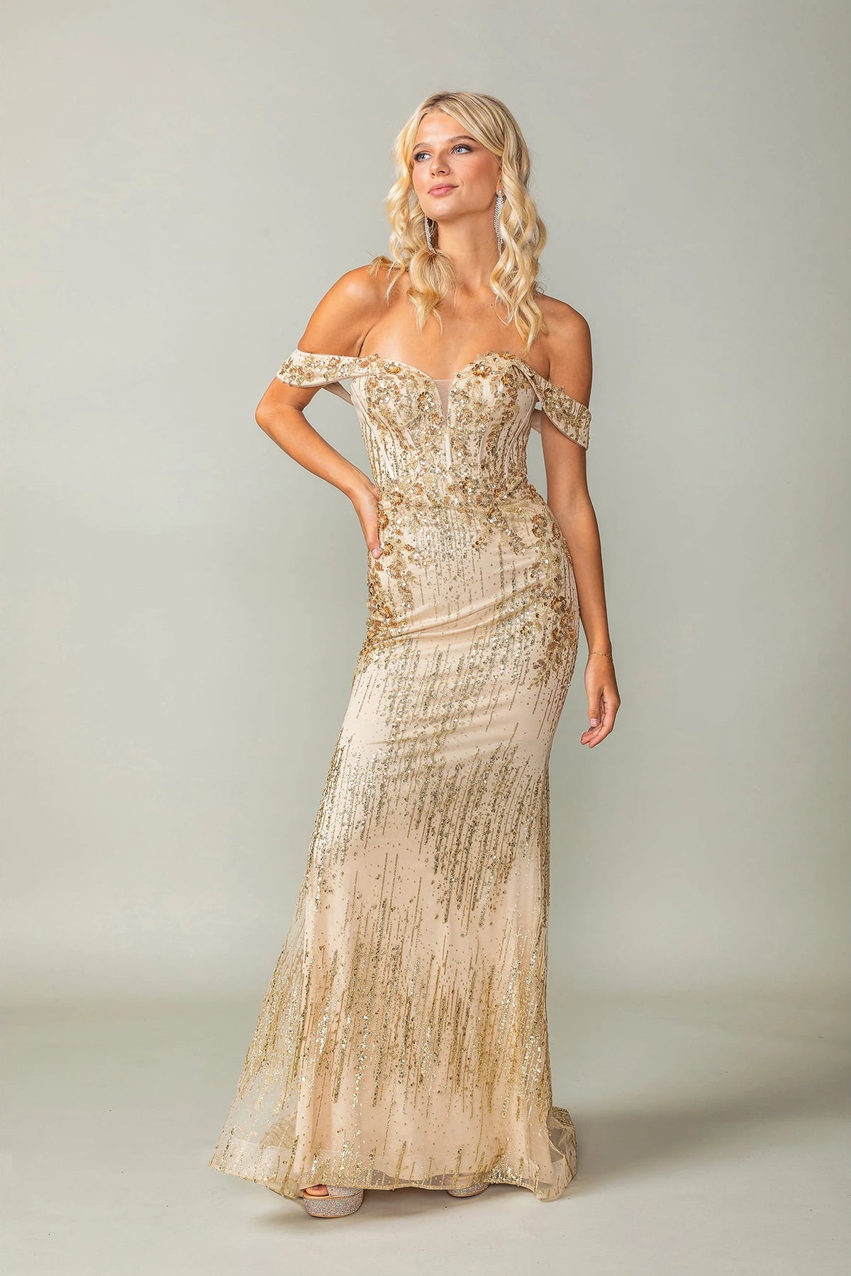 Featuring a floor-length skirt, this Gold prom dress is shown in full view.