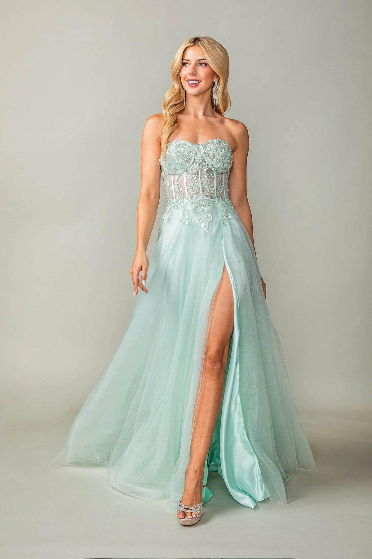 Featuring a floor-length skirt, this Mint prom dress is shown in full view.
