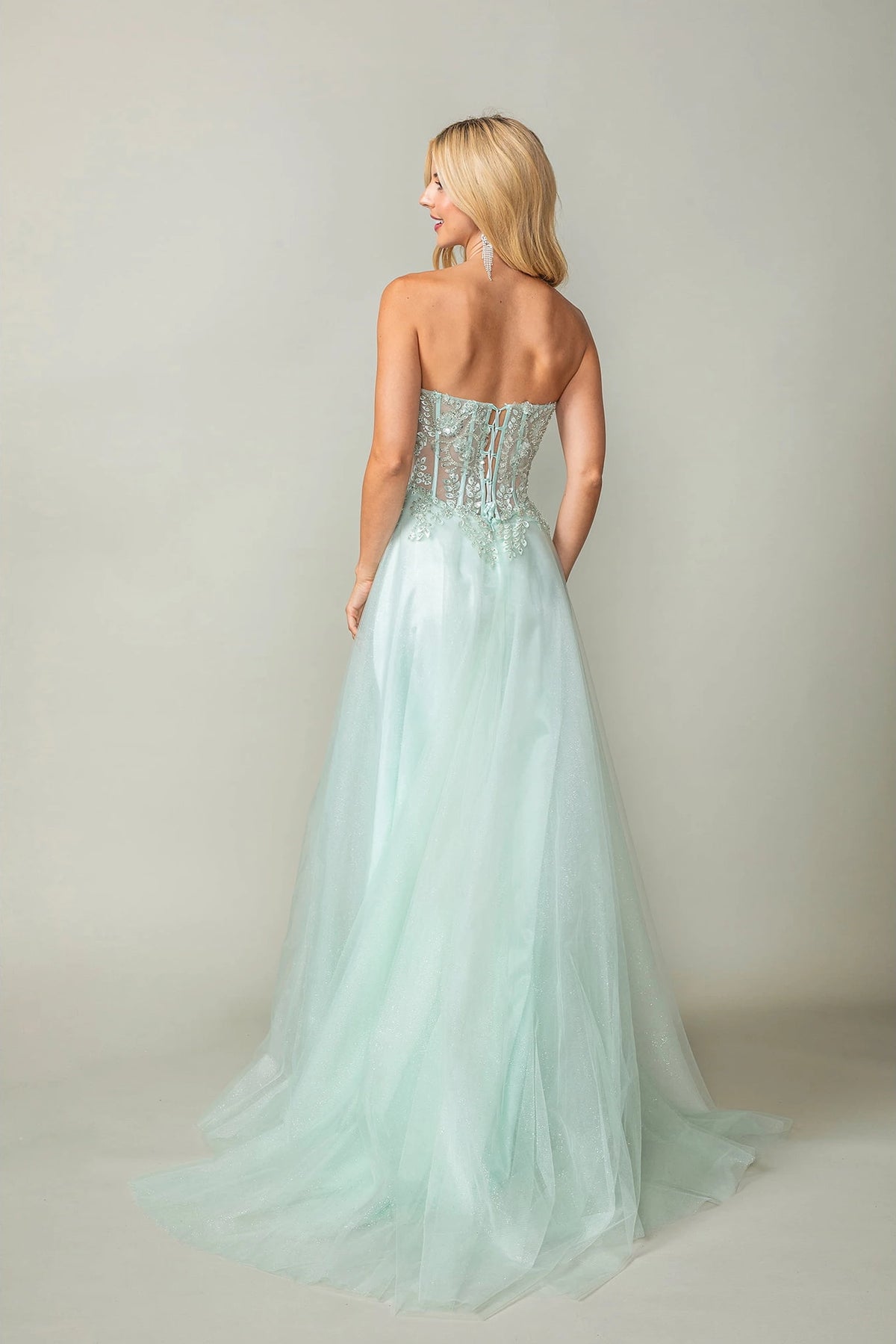 From the back, the Mint prom dress reveals its floor-length skirt.
