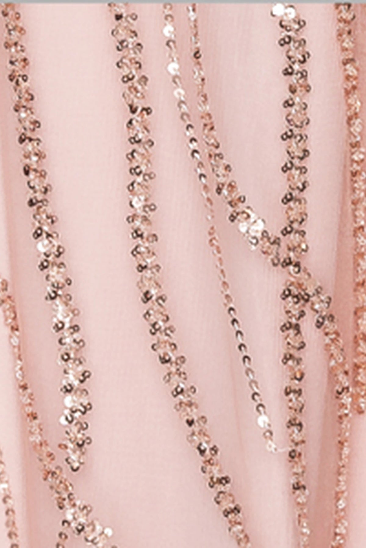 Featuring textured embellishments, this Rose Gold prom dress is shown in detail.