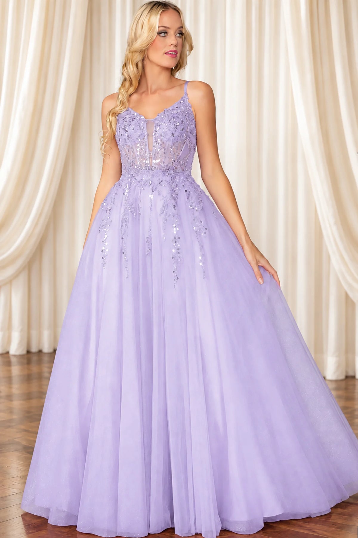 a lavender purple A-line formal gown with a lace bodice, spaghetti straps, and a voluminous tulle skirt