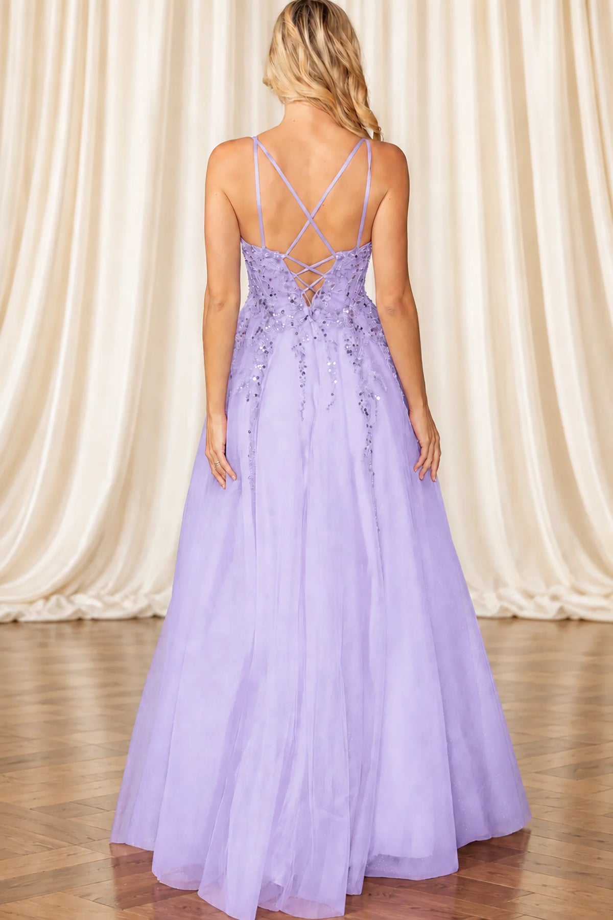 Lilac A-line evening gown with spaghetti straps, a lace-up open back, and floral beadwork on a tulle skirt