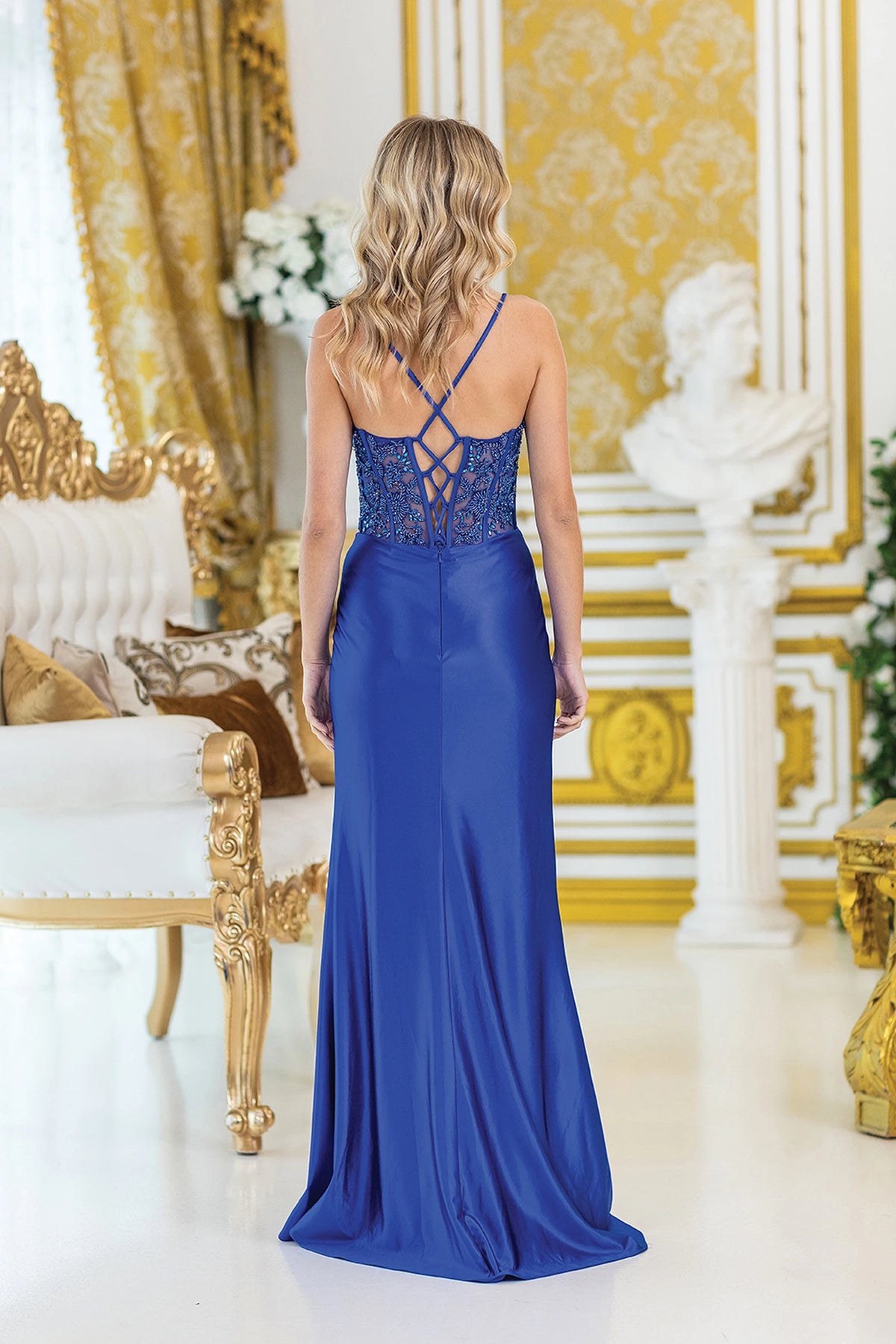 From the back, the Royal Blue prom dress reveals its floor-length skirt.