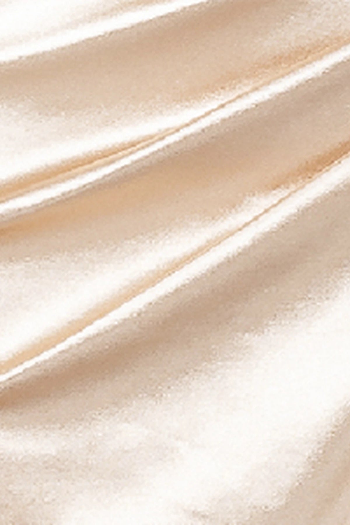 Featuring textured embellishments, this Champagne prom dress is shown in detail.