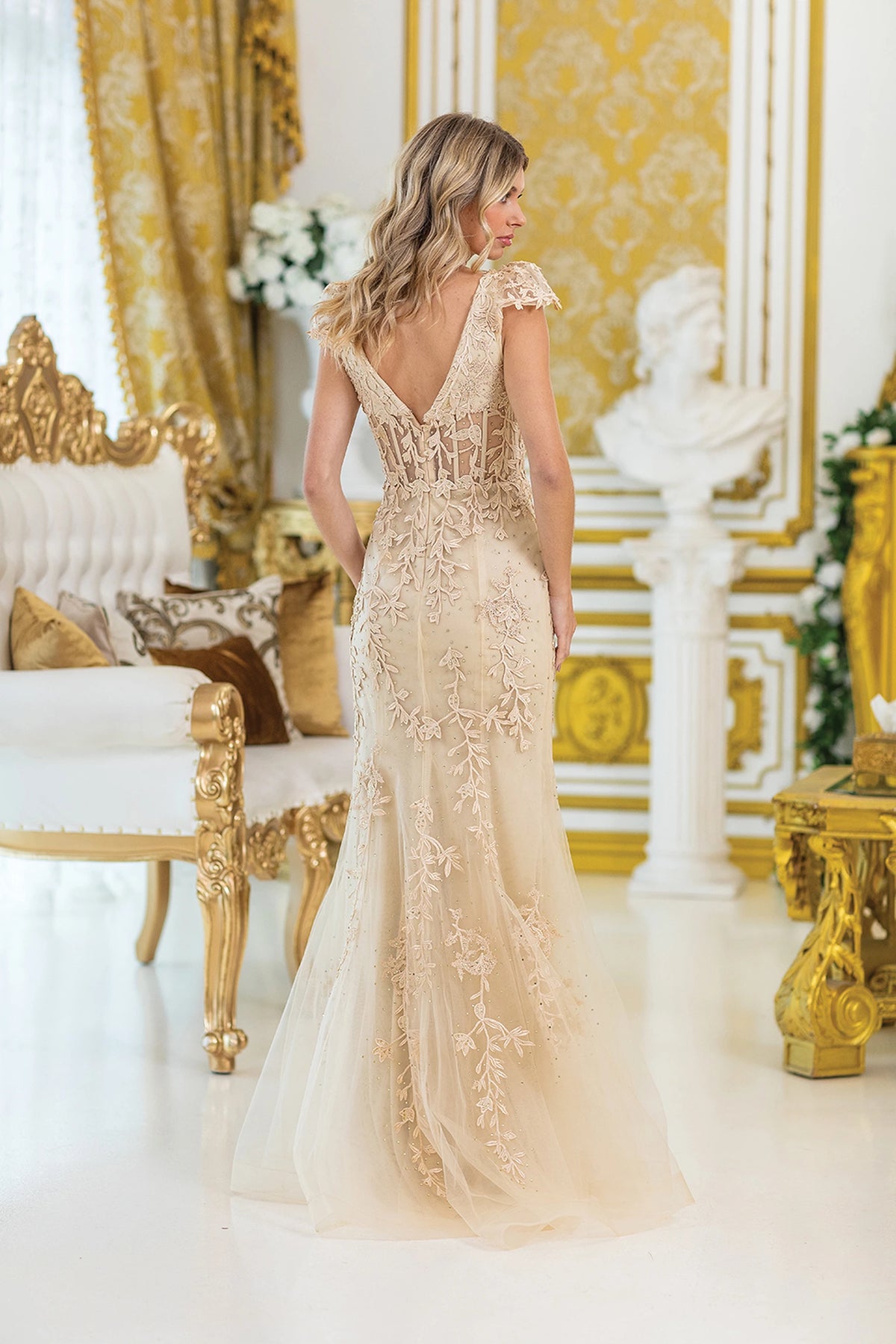 From the back, the Champagne prom dress reveals its floor-length skirt.