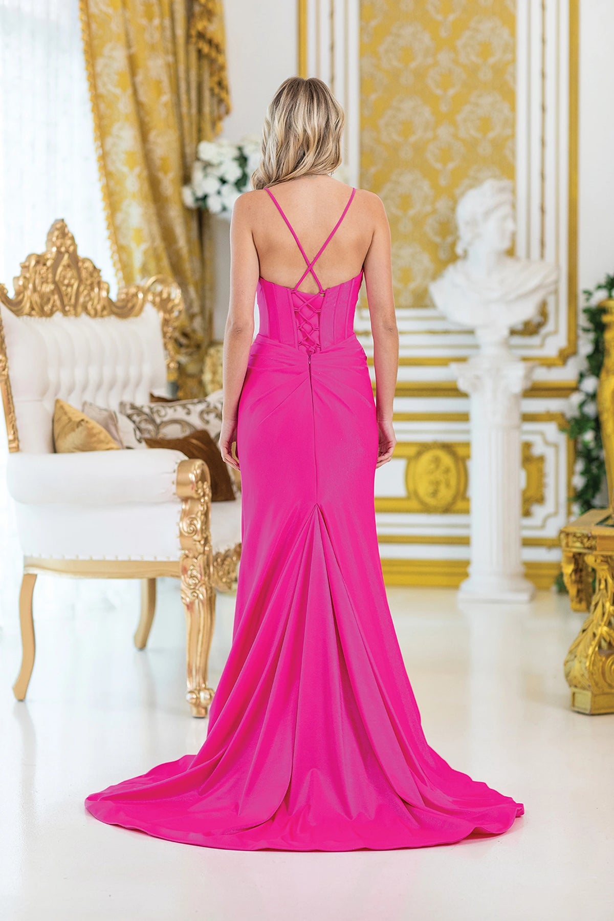 From the back, the Fuchsia prom dress reveals its floor-length skirt.