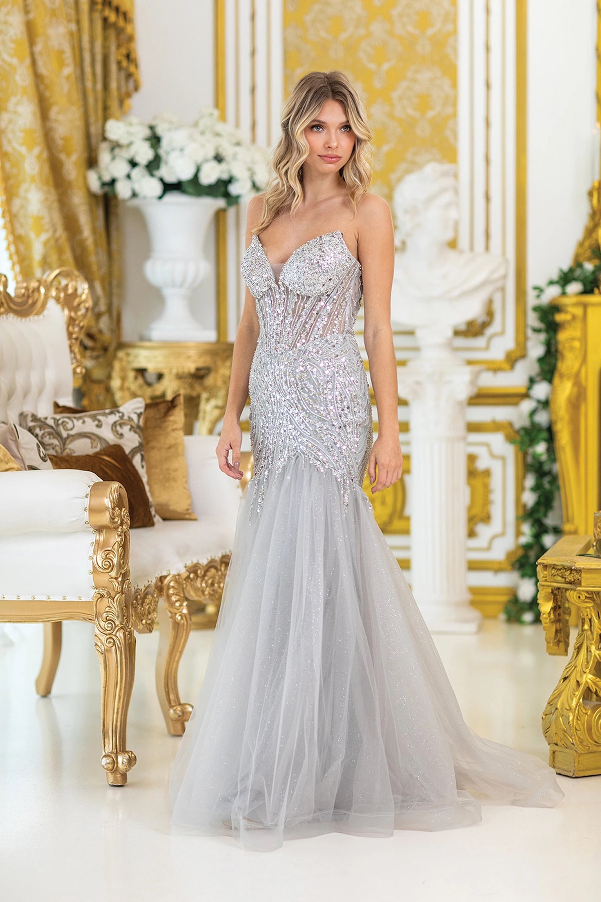 Featuring a floor-length skirt, this Silver prom dress is shown in full view.