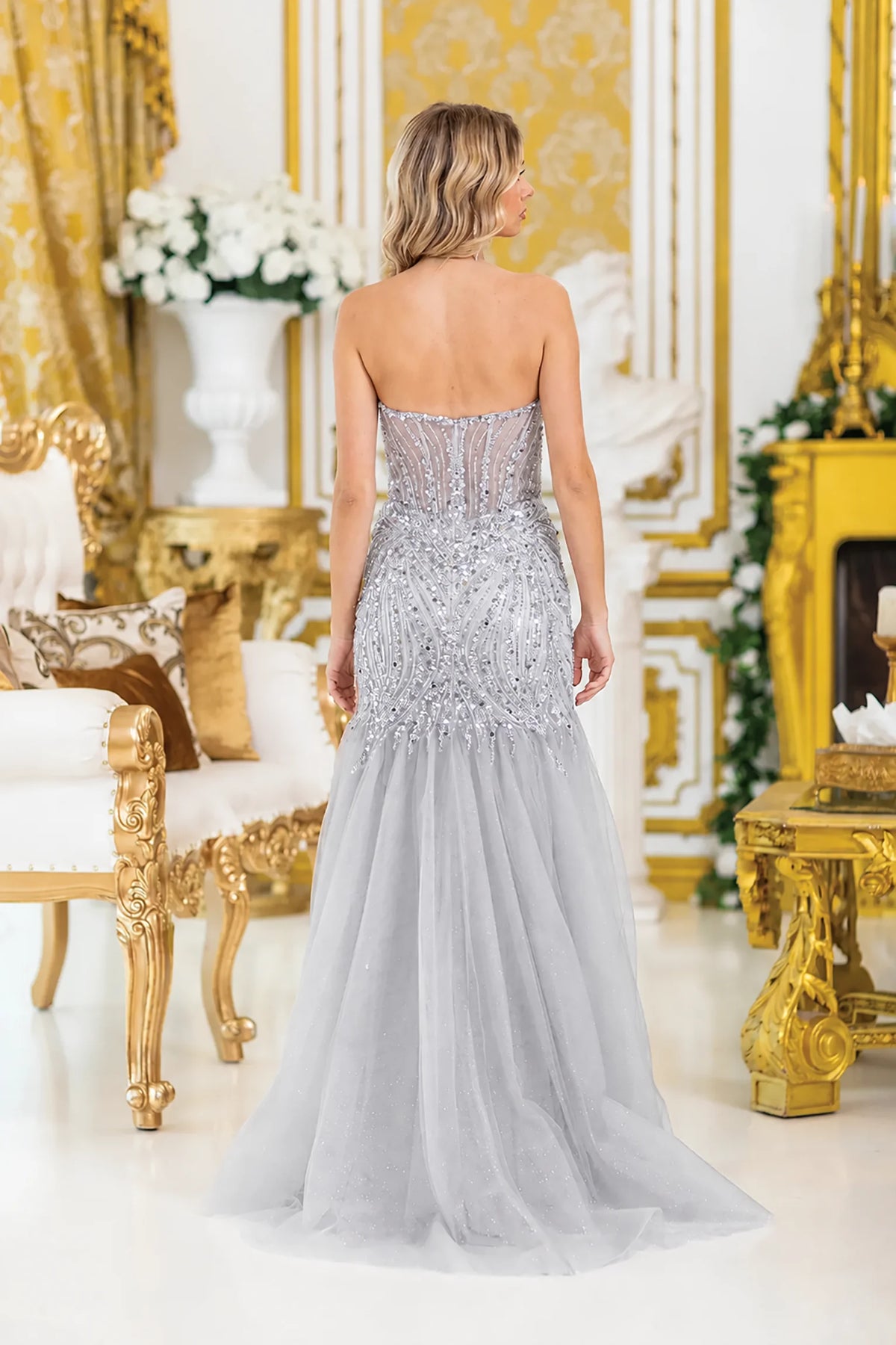 a strapless silver tulle evening gown with heavy beading on the bodice