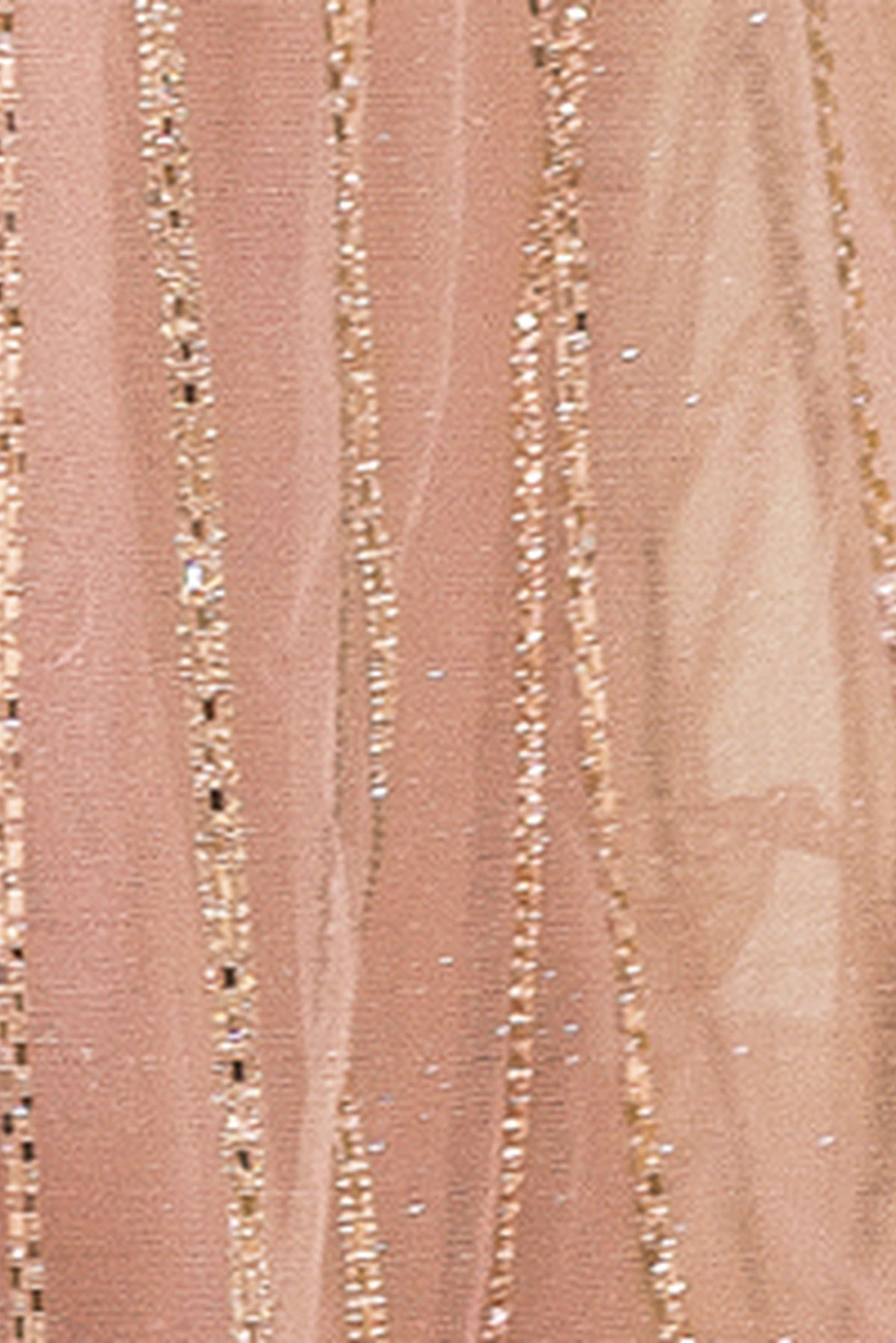 Featuring textured embellishments, this Rose Gold prom dress is shown in detail.