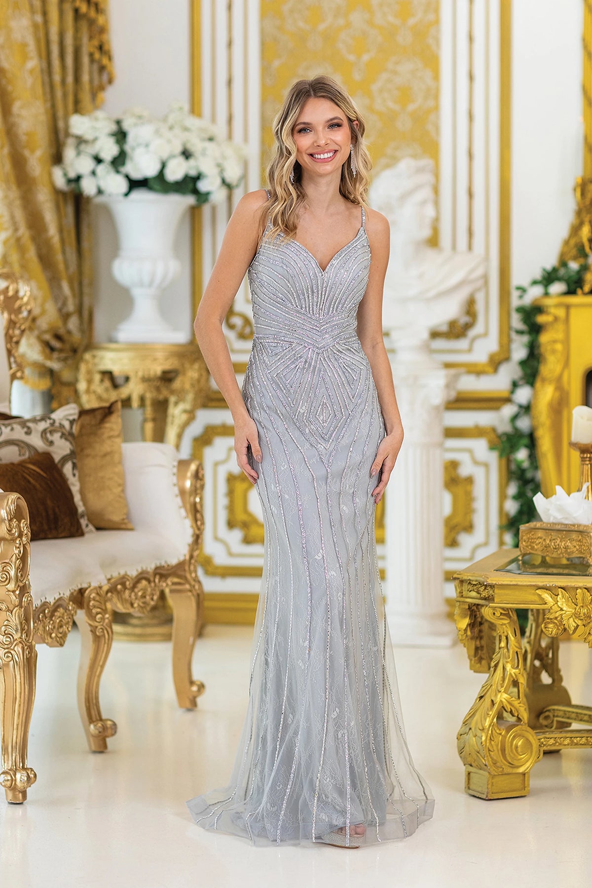 Featuring a floor-length skirt, this Silver prom dress is shown in full view.