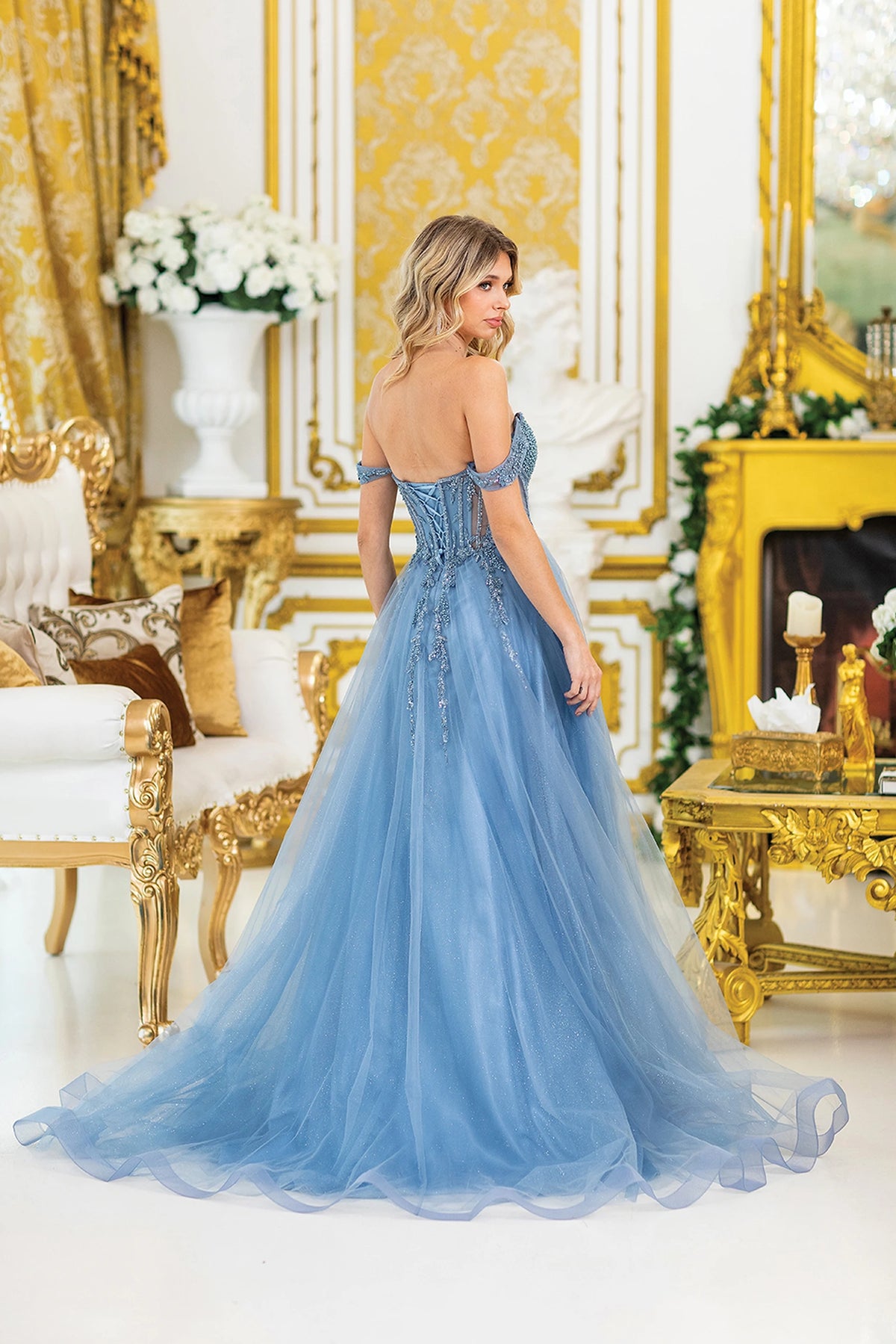 From the back, the Dusty Blue prom dress reveals its floor-length skirt.
