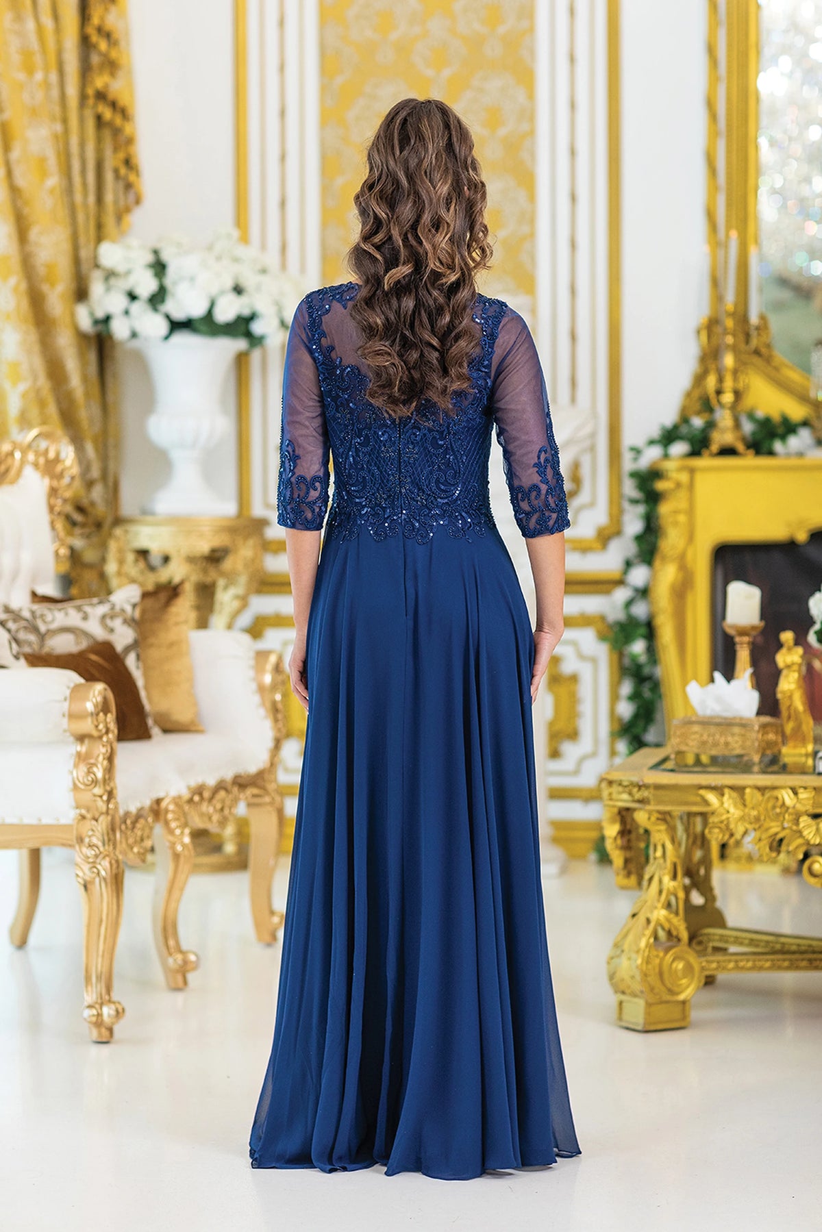 From the back, the Navy prom dress reveals its floor-length skirt.