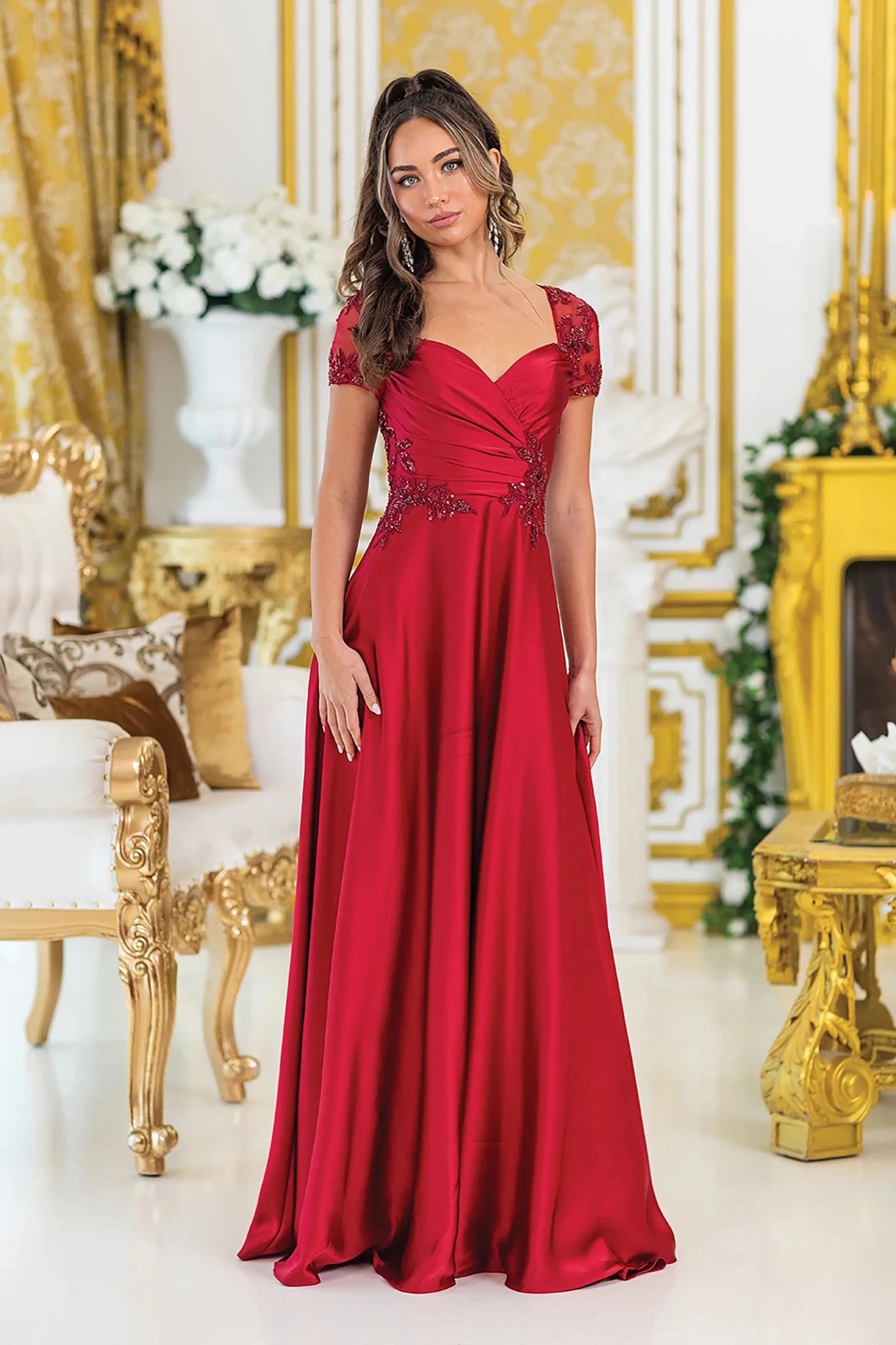 Woman in Burgundy A-line prom dress with floral lace and short sleeves.