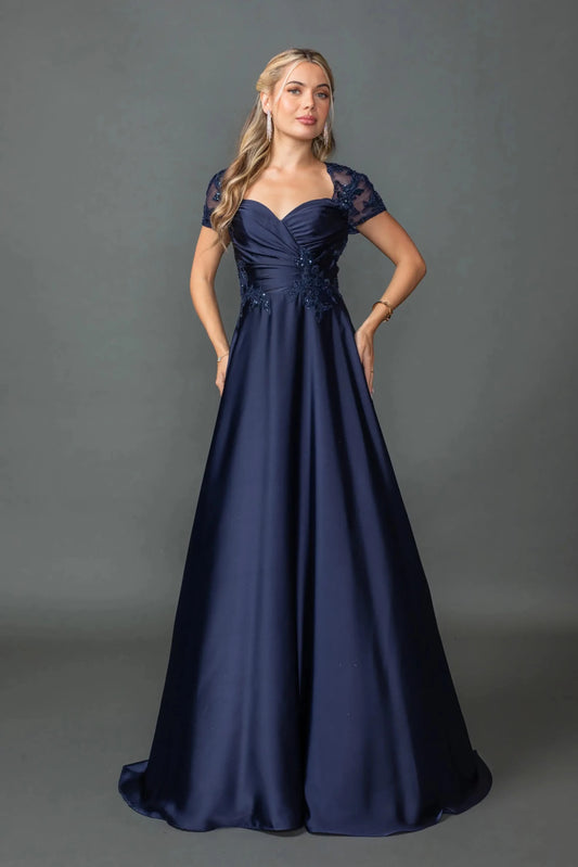 Woman in Navy A-line prom dress with floral lace and short sleeves.