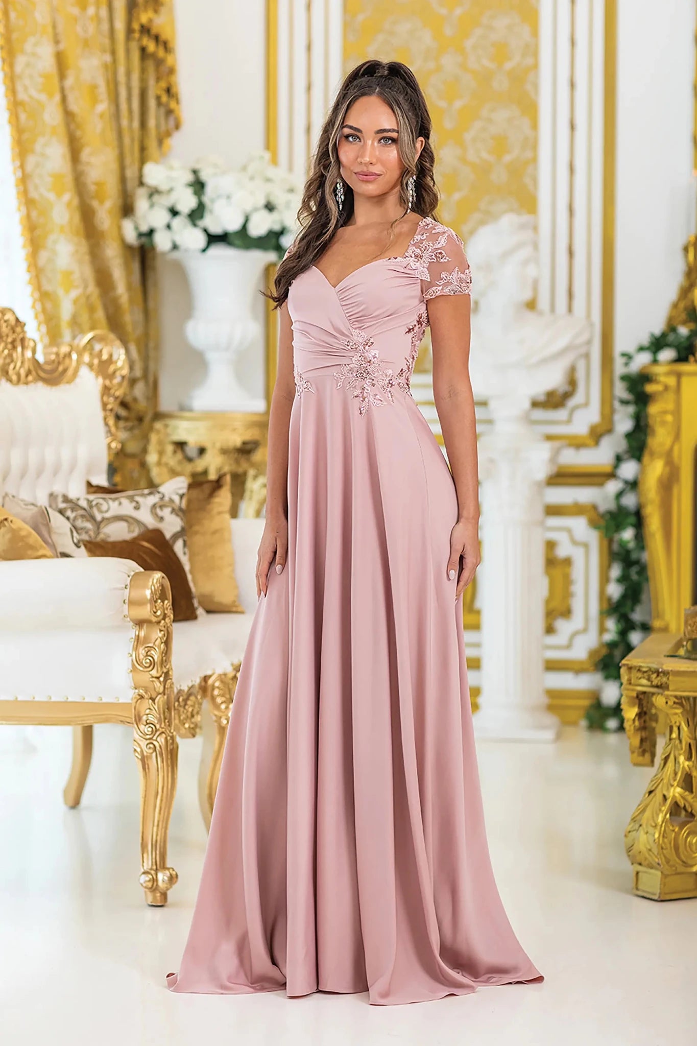 Woman in Rose Gold A-line prom dress with floral lace and short sleeves.