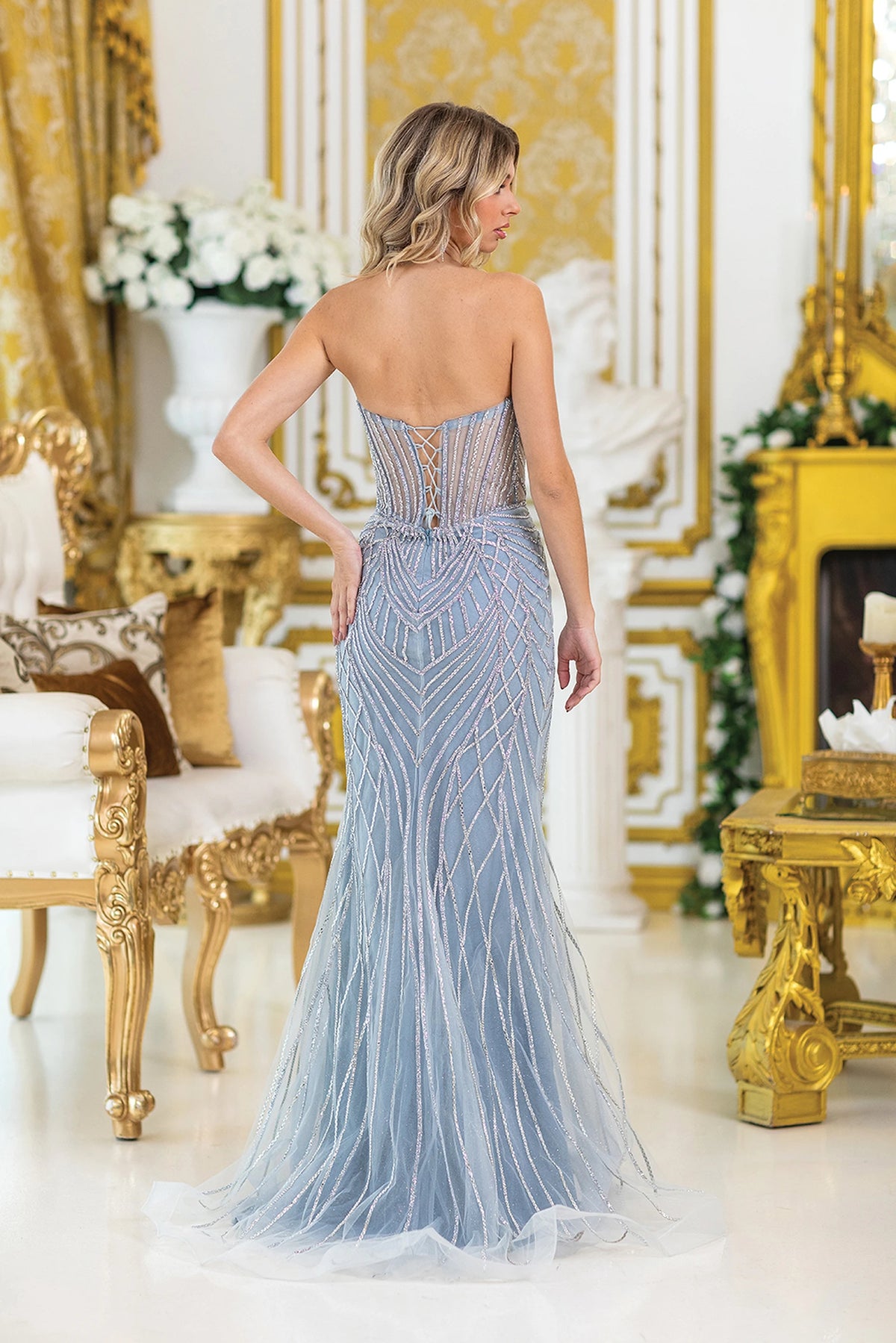 From the back, the Dusty Blue prom dress reveals its floor-length skirt.