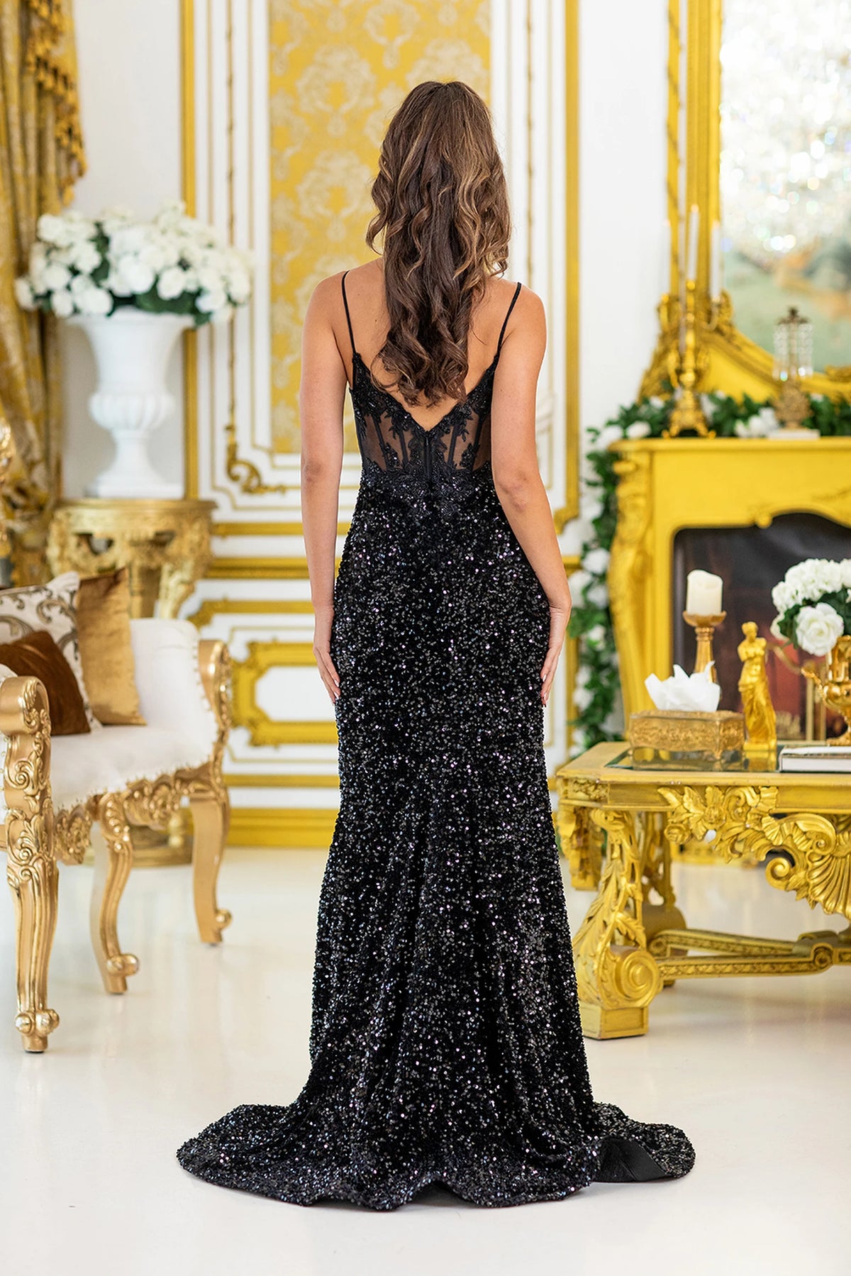 From the back, the Black prom dress reveals its floor-length skirt.