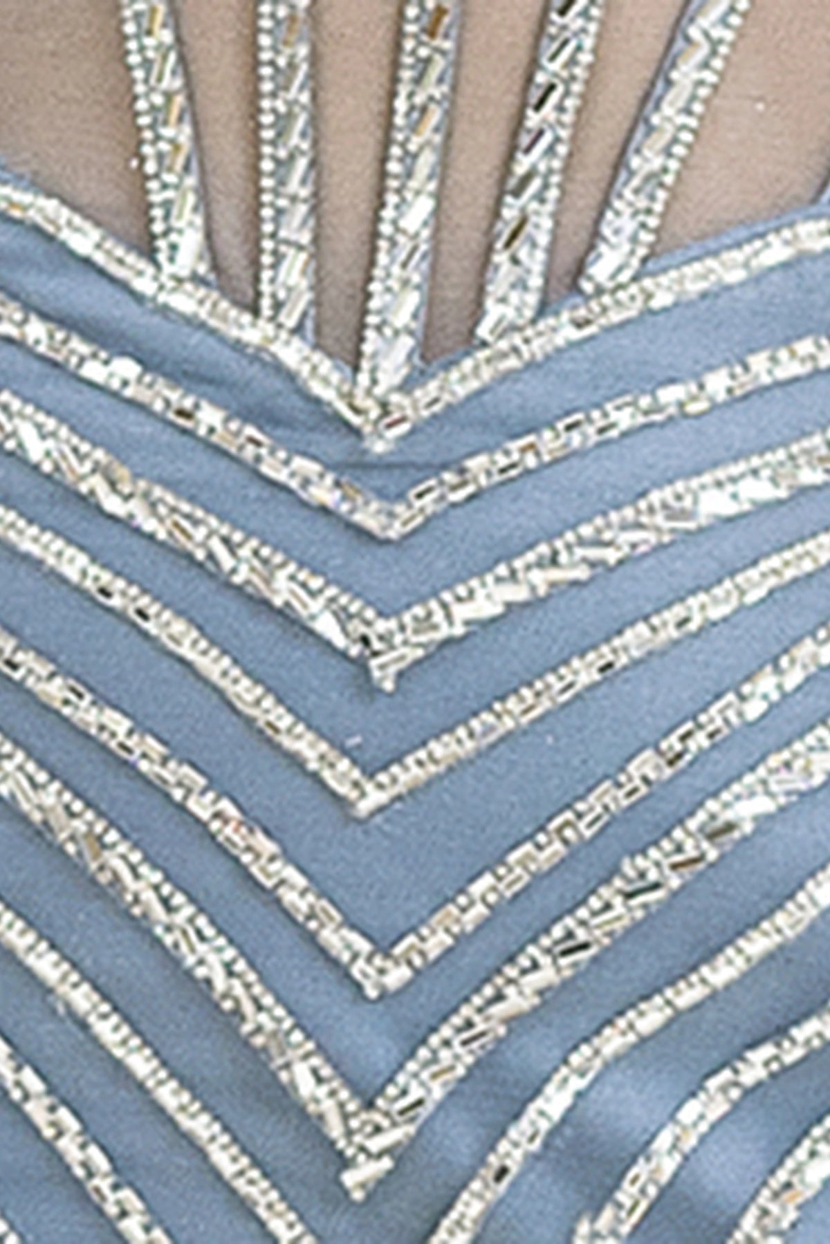 Featuring textured embellishments, this Dusty Blue prom dress is shown in detail.