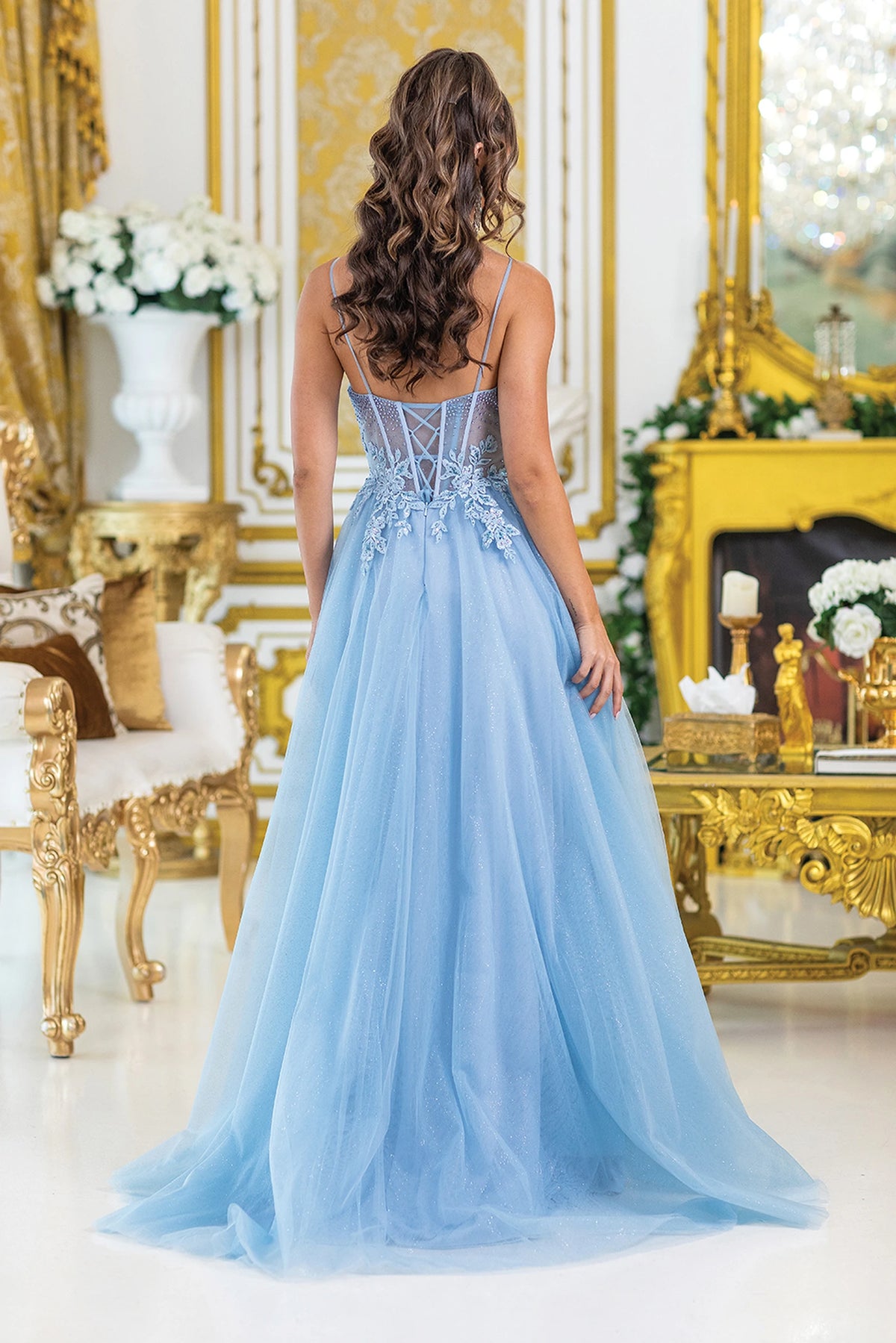 From the back, the Dusty Blue prom dress reveals its floor-length skirt.