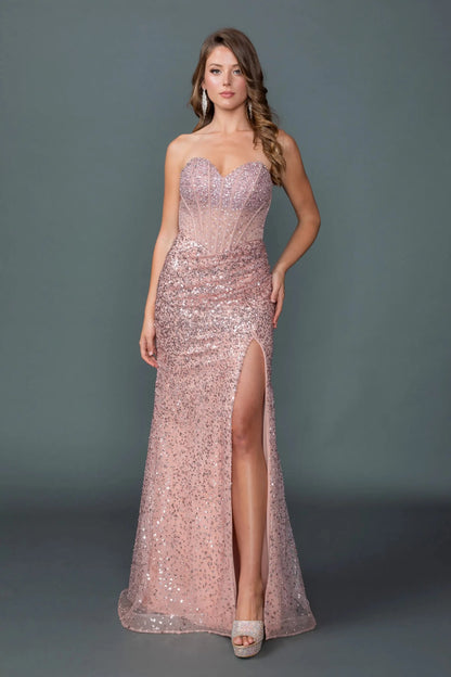 Woman in Dusty Rose strapless prom dress with sequin bodice and slit skirt.