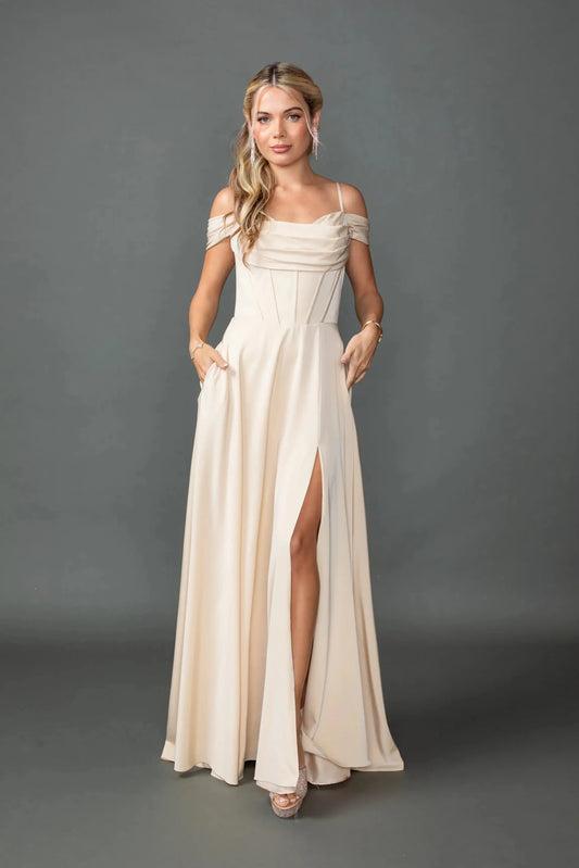 Showing a draped cowl neckline and high-slit skirt, this Champagne prom dress is shown in full view.