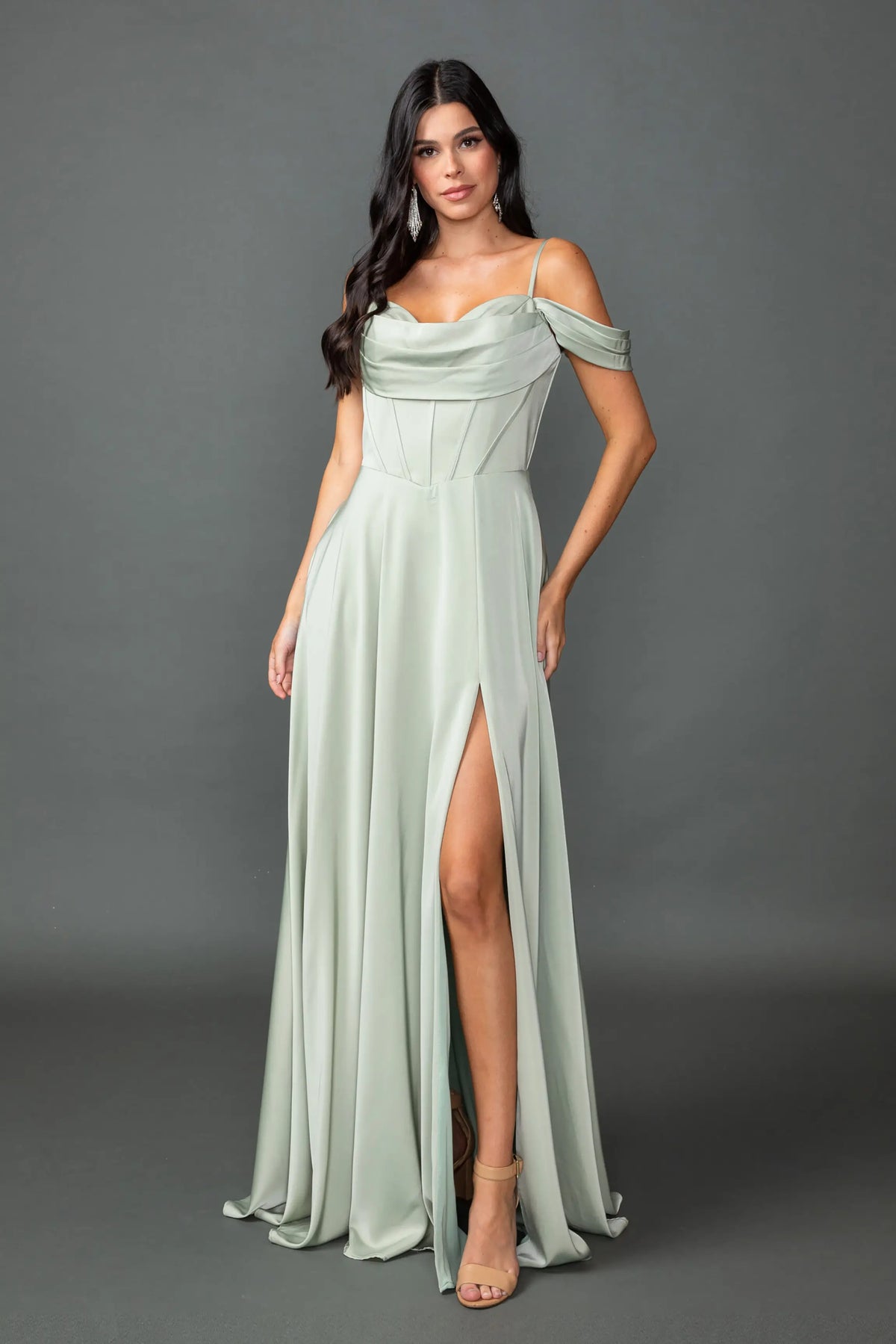 Showing a draped cowl neckline and high-slit skirt, this Light Sage prom dress is shown in full view.