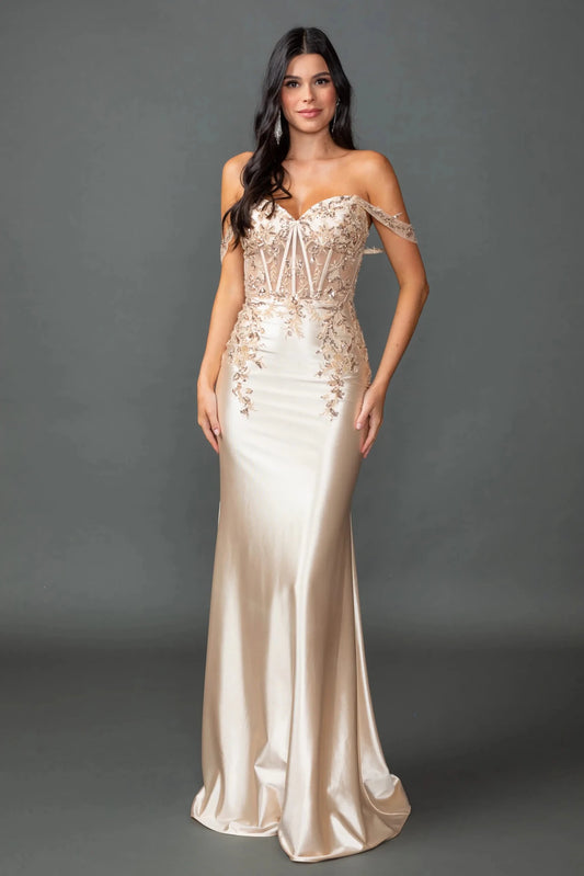 Showing beaded corset detailing above its satin skirt, this Champagne prom dress is shown in full view.