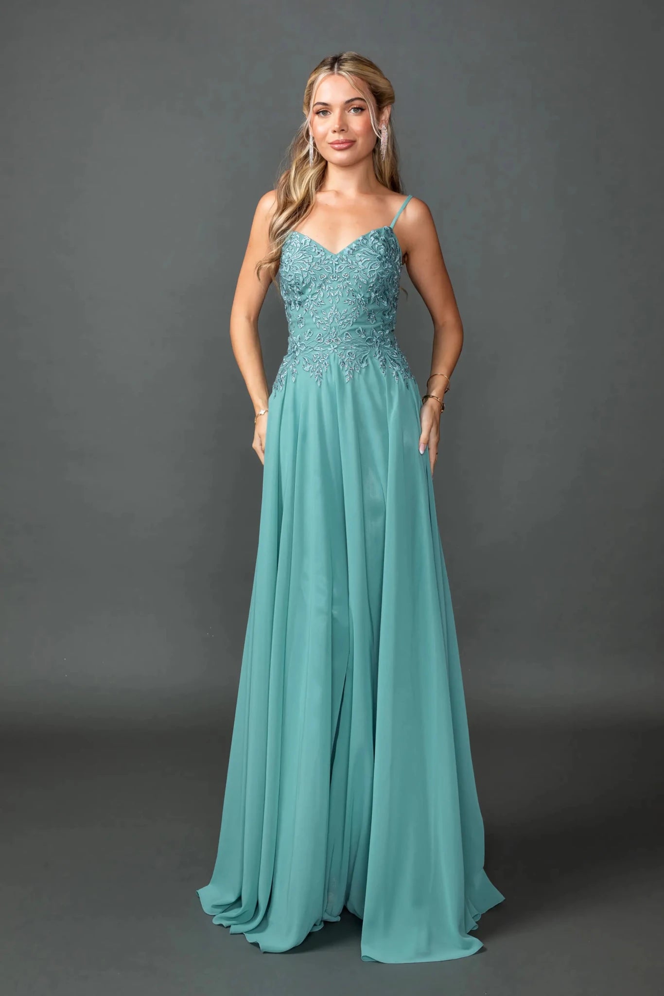 Woman in Sage chiffon prom dress with embroidered bodice and bolero jacket.