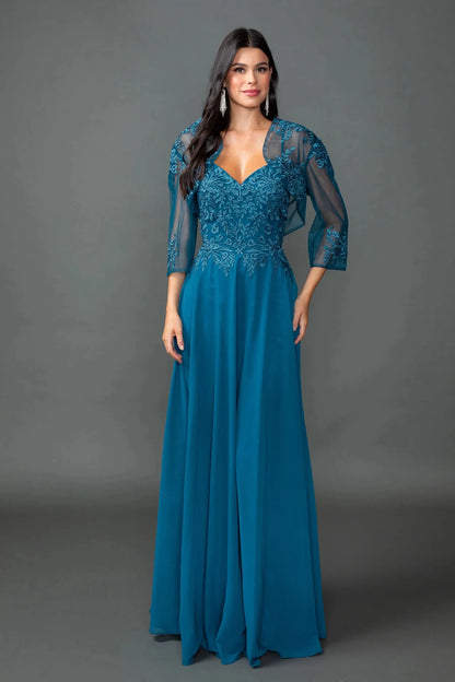 Woman in Teal chiffon prom dress with embroidered bodice and bolero jacket.