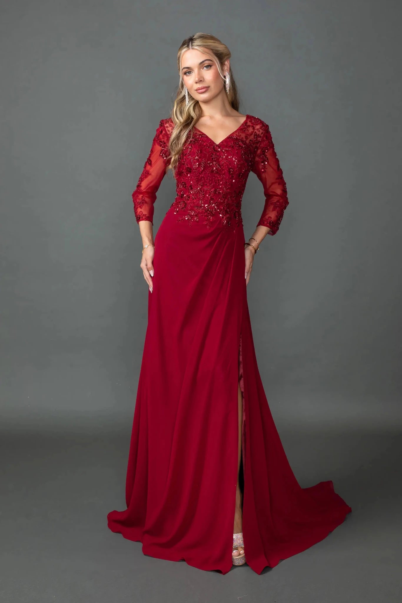 Woman in Burgundy chiffon prom dress with embroidered bodice and side slit.
