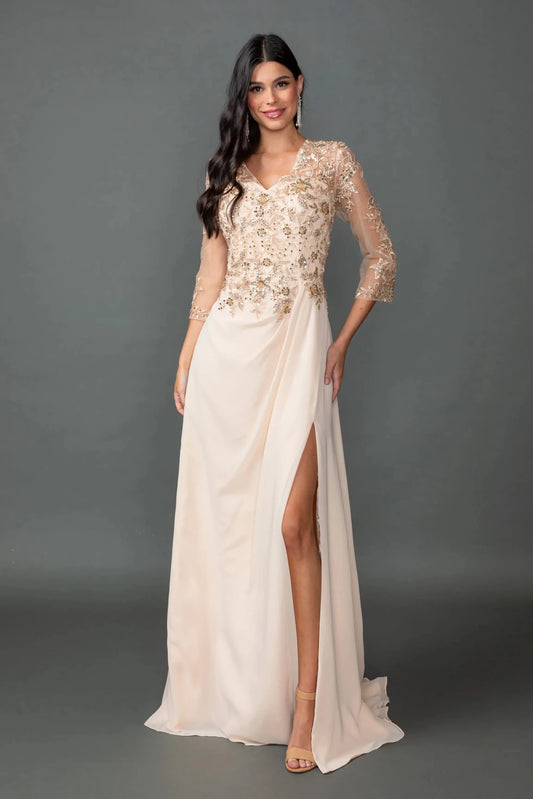Woman in Champagne chiffon prom dress with embroidered bodice and side slit.