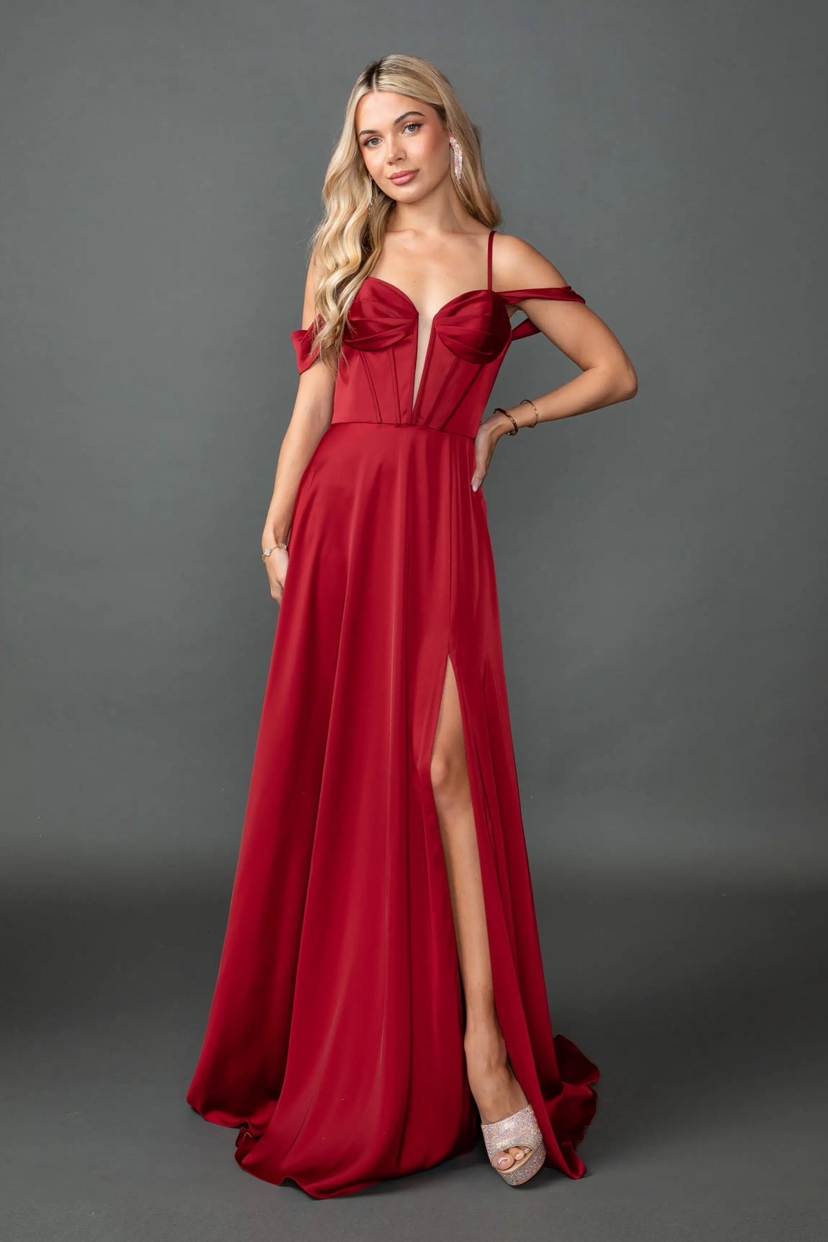 Showing a sweetheart bodice and high-slit satin skirt, this Burgundy prom dress is shown in full view.