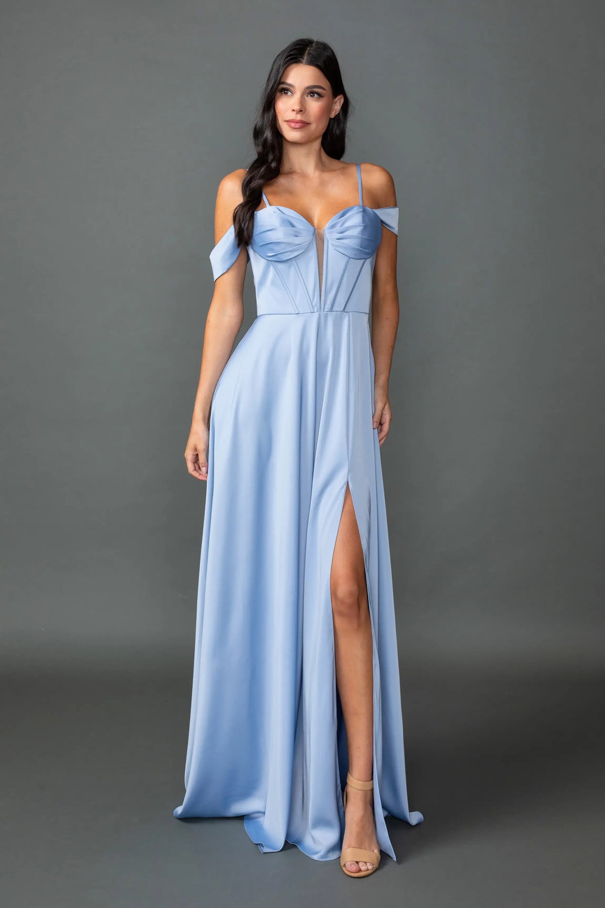 Showing a sweetheart bodice and high-slit satin skirt, this Dusty Blue prom dress is shown in full view.