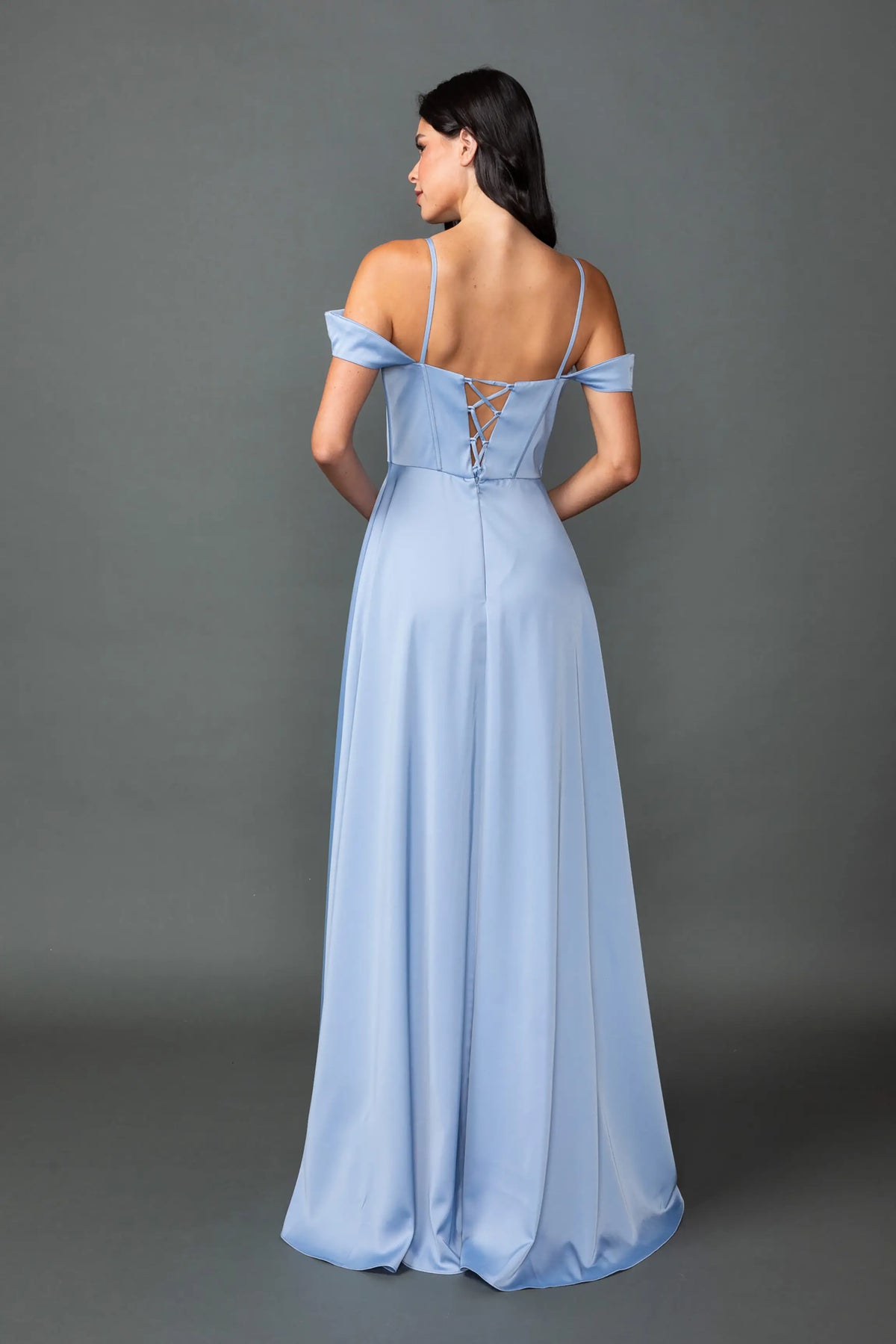 Revealing a structured bodice above its flowing satin skirt, this Dusty Blue prom dress is shown from the back.