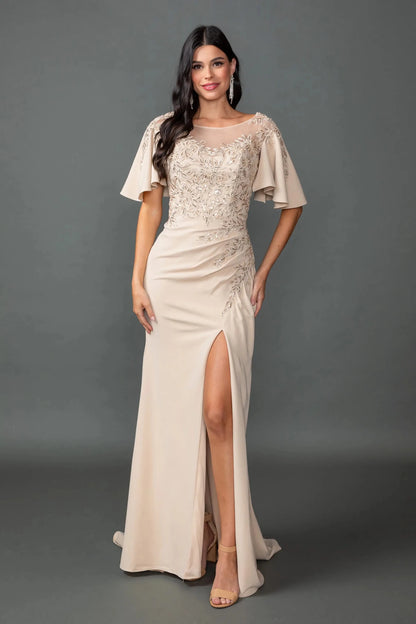 Woman in Champagne prom dress with illusion neckline and high slit.