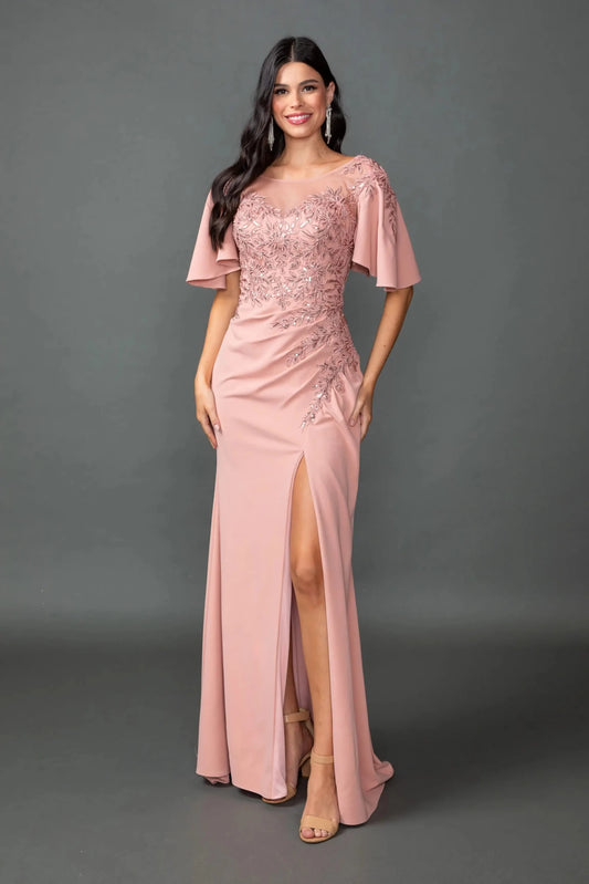 Woman in Rose Gold prom dress with illusion neckline and high slit.