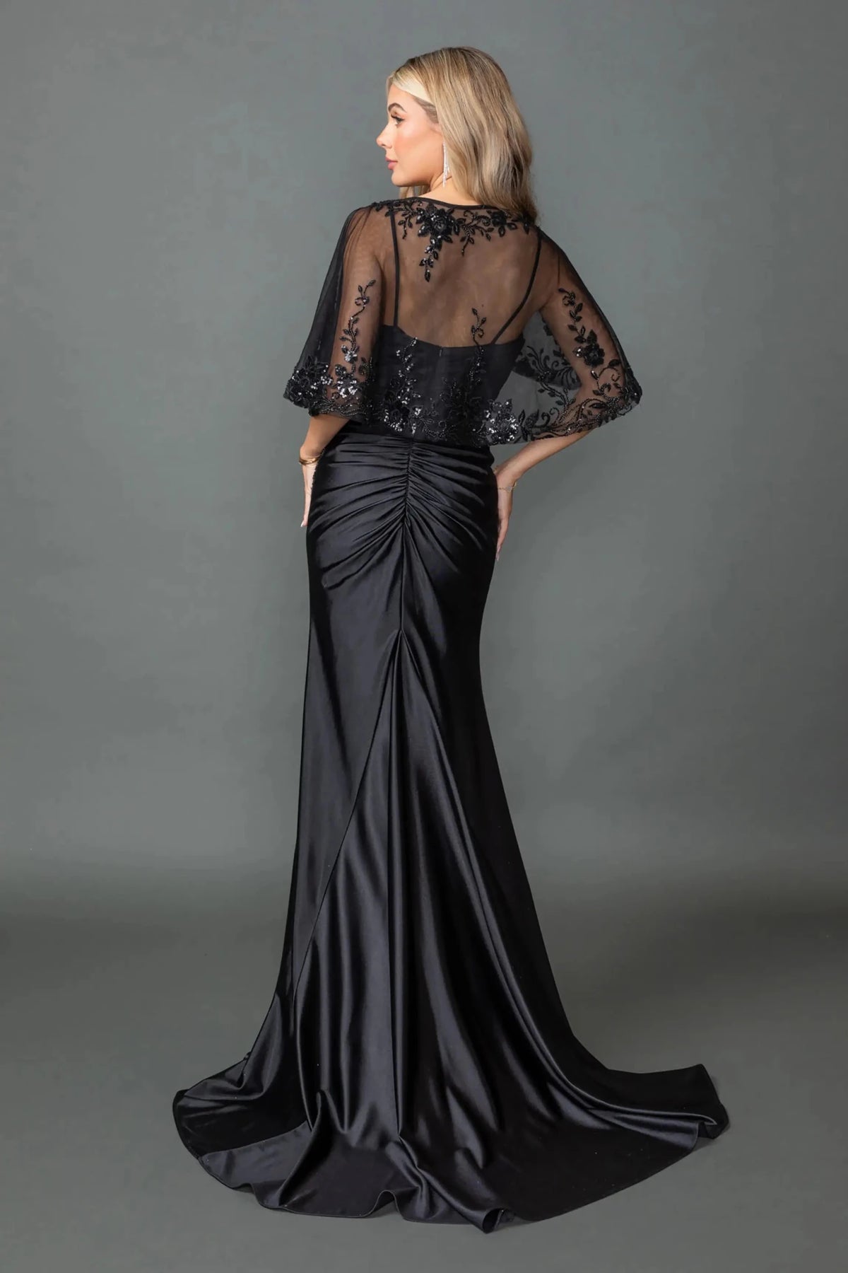 Black evening dress styled with removable sheer flutter cape and zipper closure