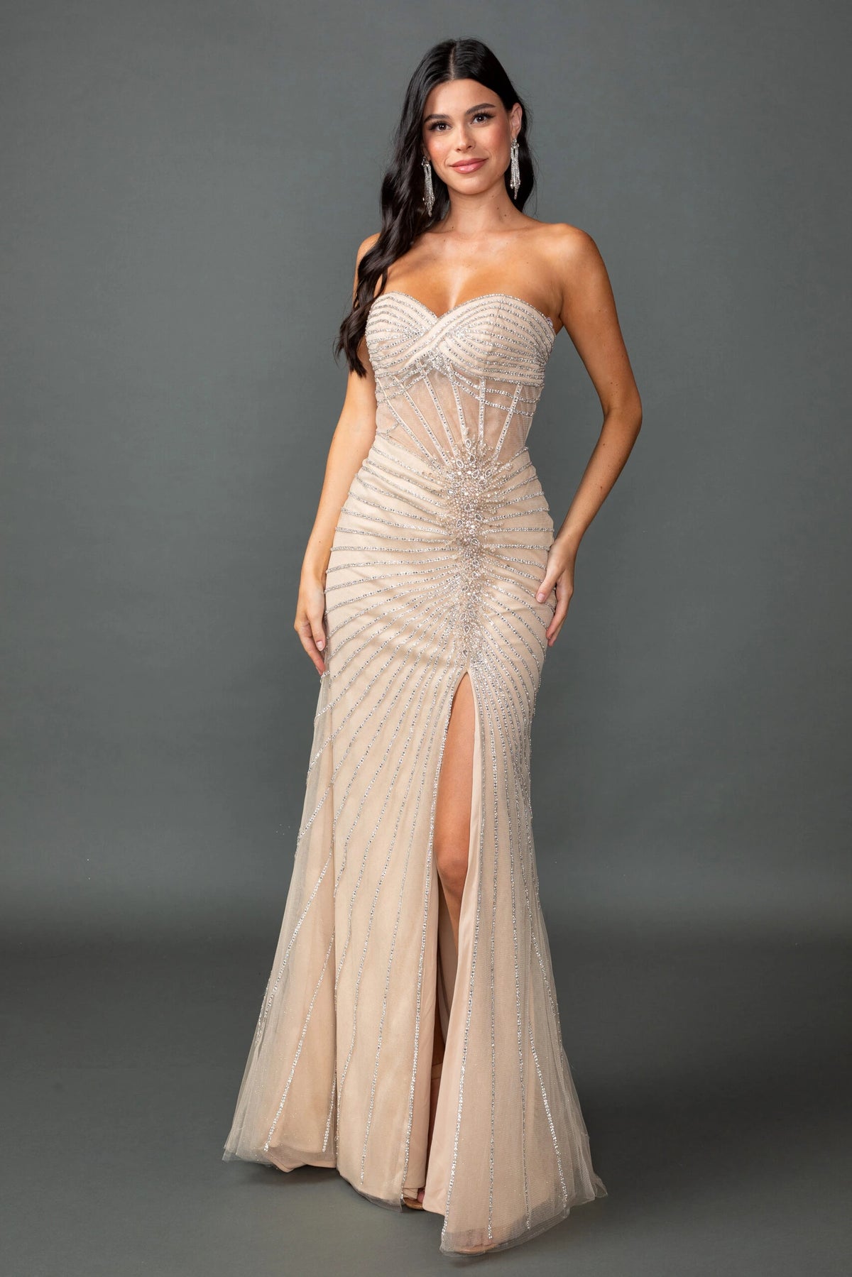 Featuring a floor-length skirt, this Champagne prom dress is shown in full view.