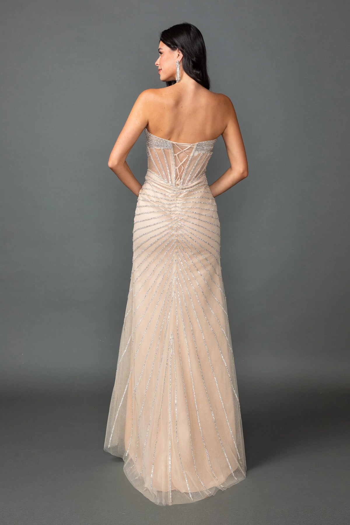 From the back, the Champagne prom dress reveals its floor-length skirt.