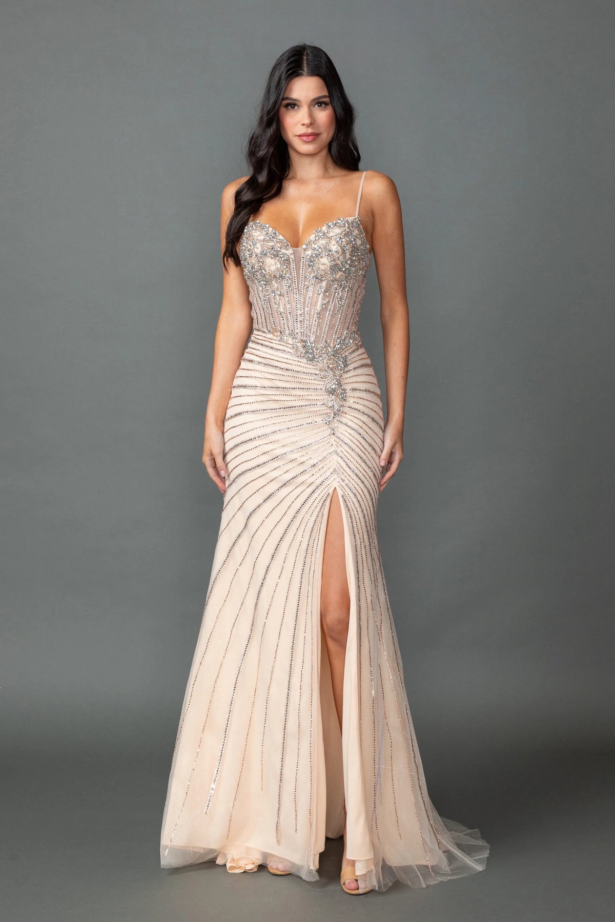Featuring a floor-length skirt, this Champagne prom dress is shown in full view.