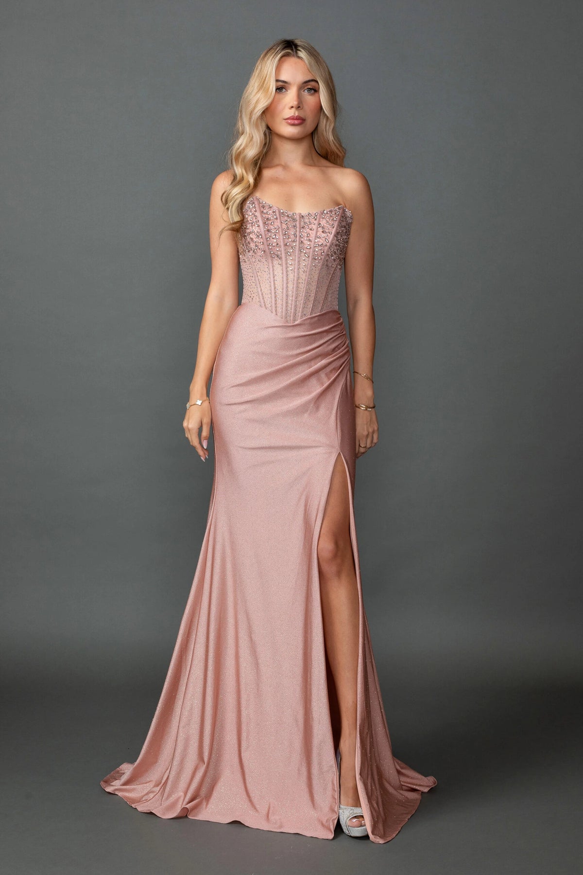 Featuring a floor-length skirt, this Rose Gold prom dress is shown in full view.