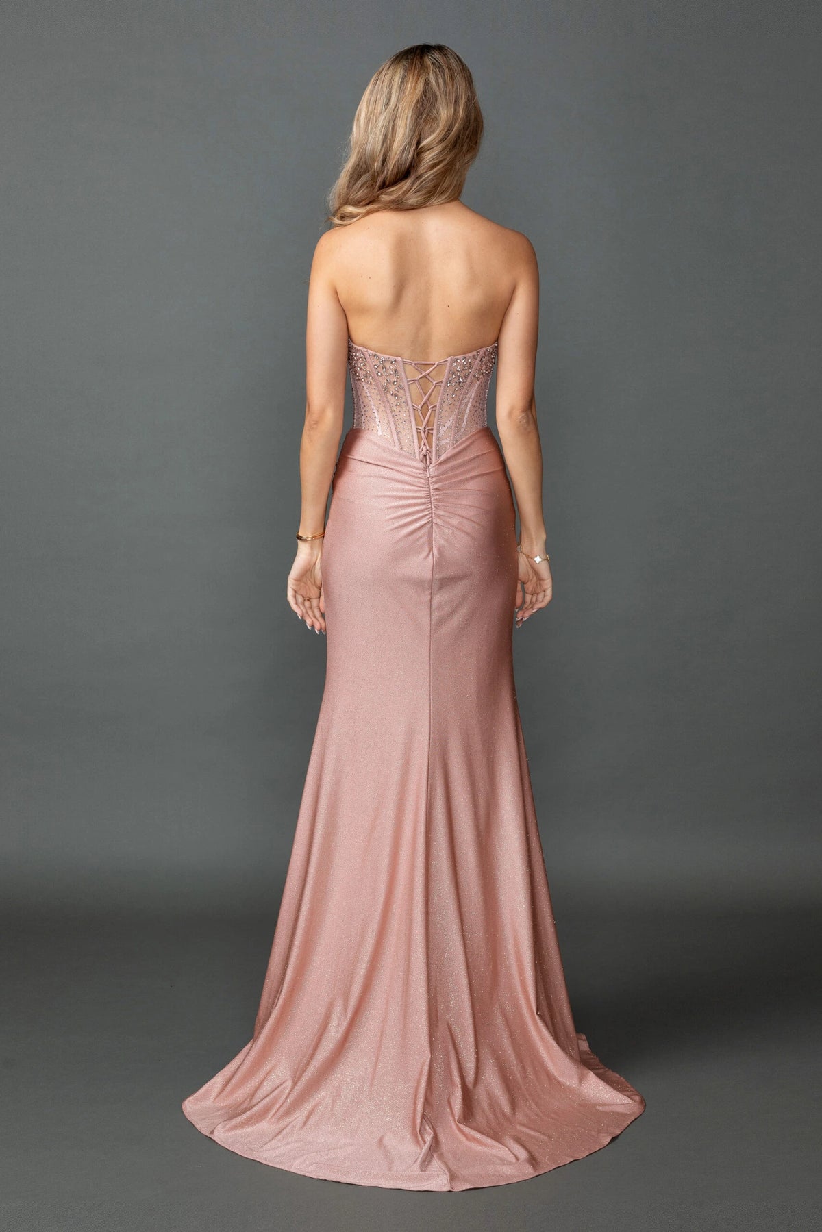 From the back, the Rose Gold prom dress reveals its floor-length skirt.