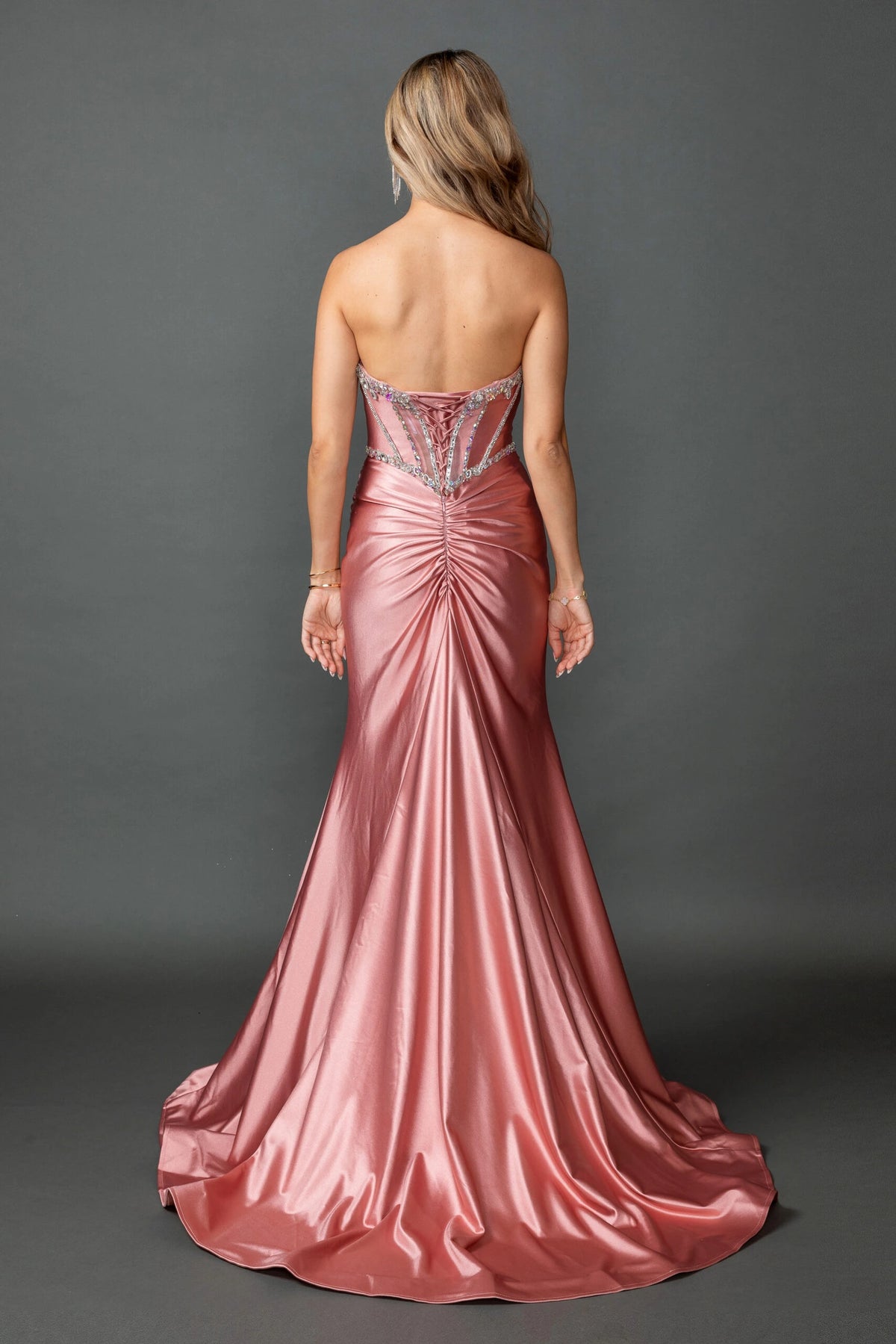 From the back, the Rose Gold prom dress reveals its floor-length skirt.