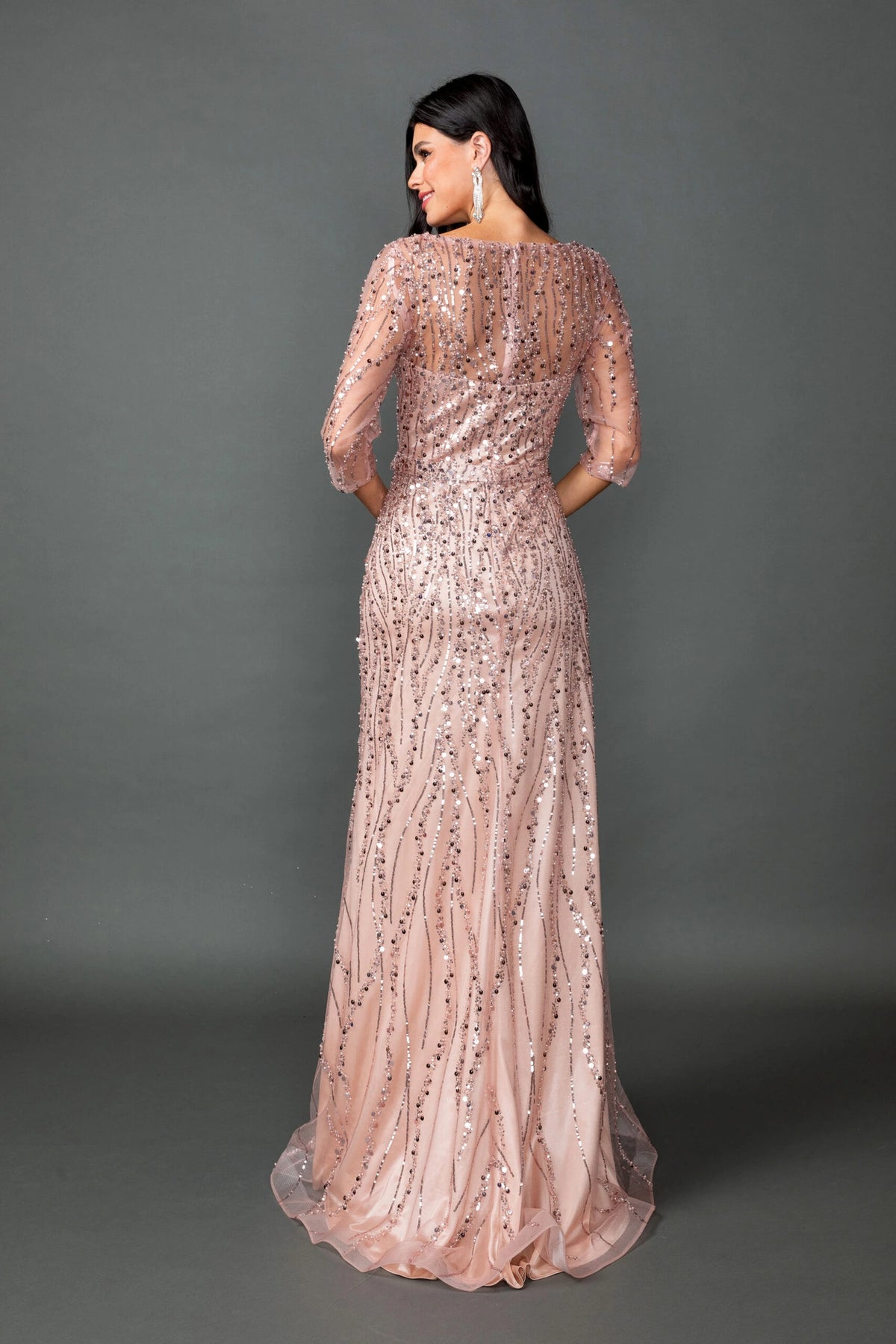 From the back, the Rose Gold prom dress reveals its floor-length skirt.