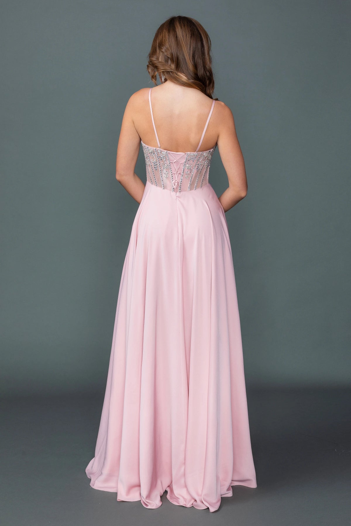 From the back, the Blush prom dress reveals its floor-length skirt.