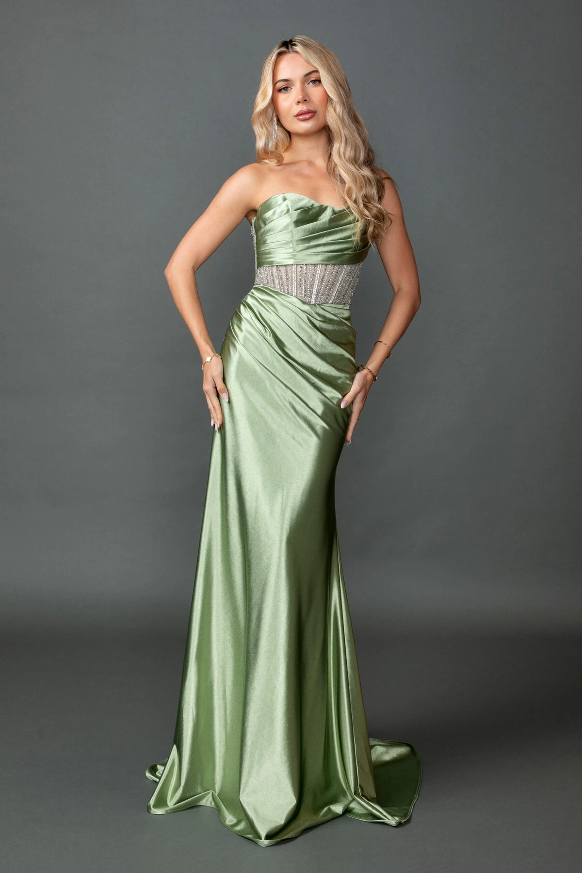 Featuring a floor-length skirt, this Olive prom dress is shown in full view.